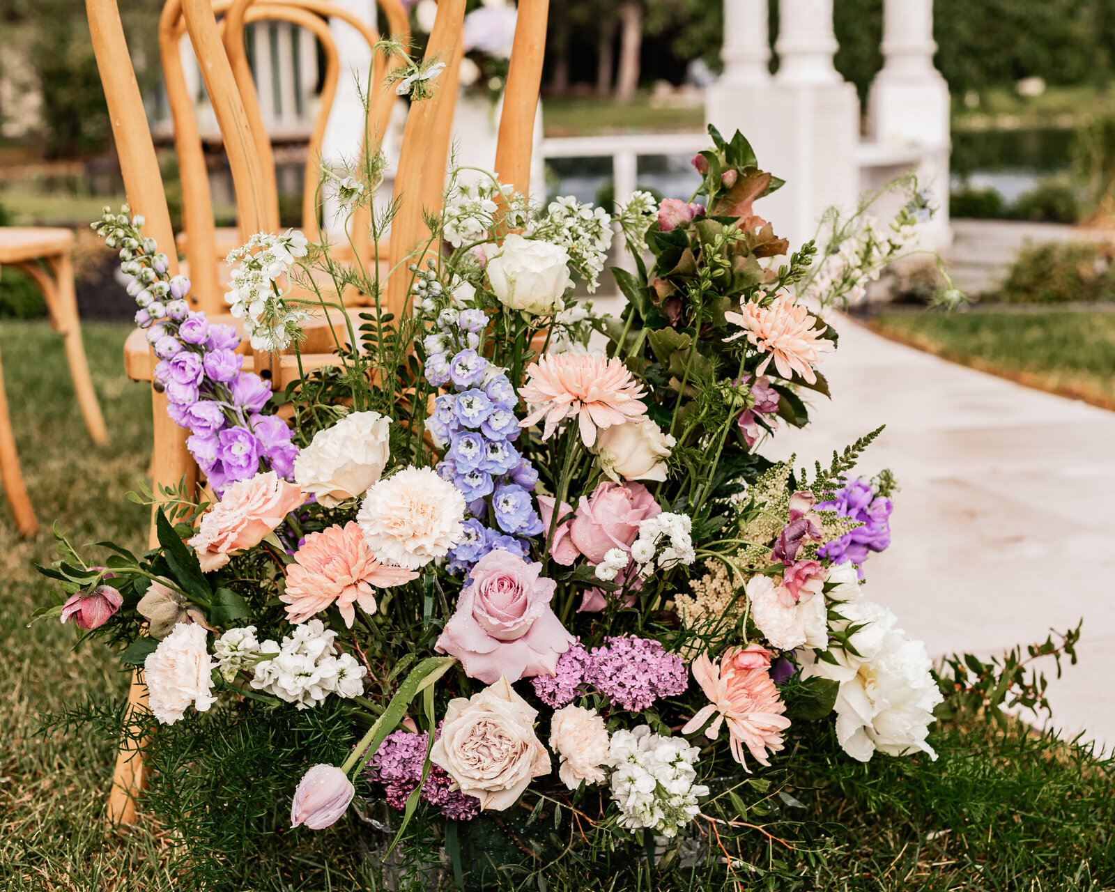 Floral arrangement set up at the end of the aisle for a wedding ceremony