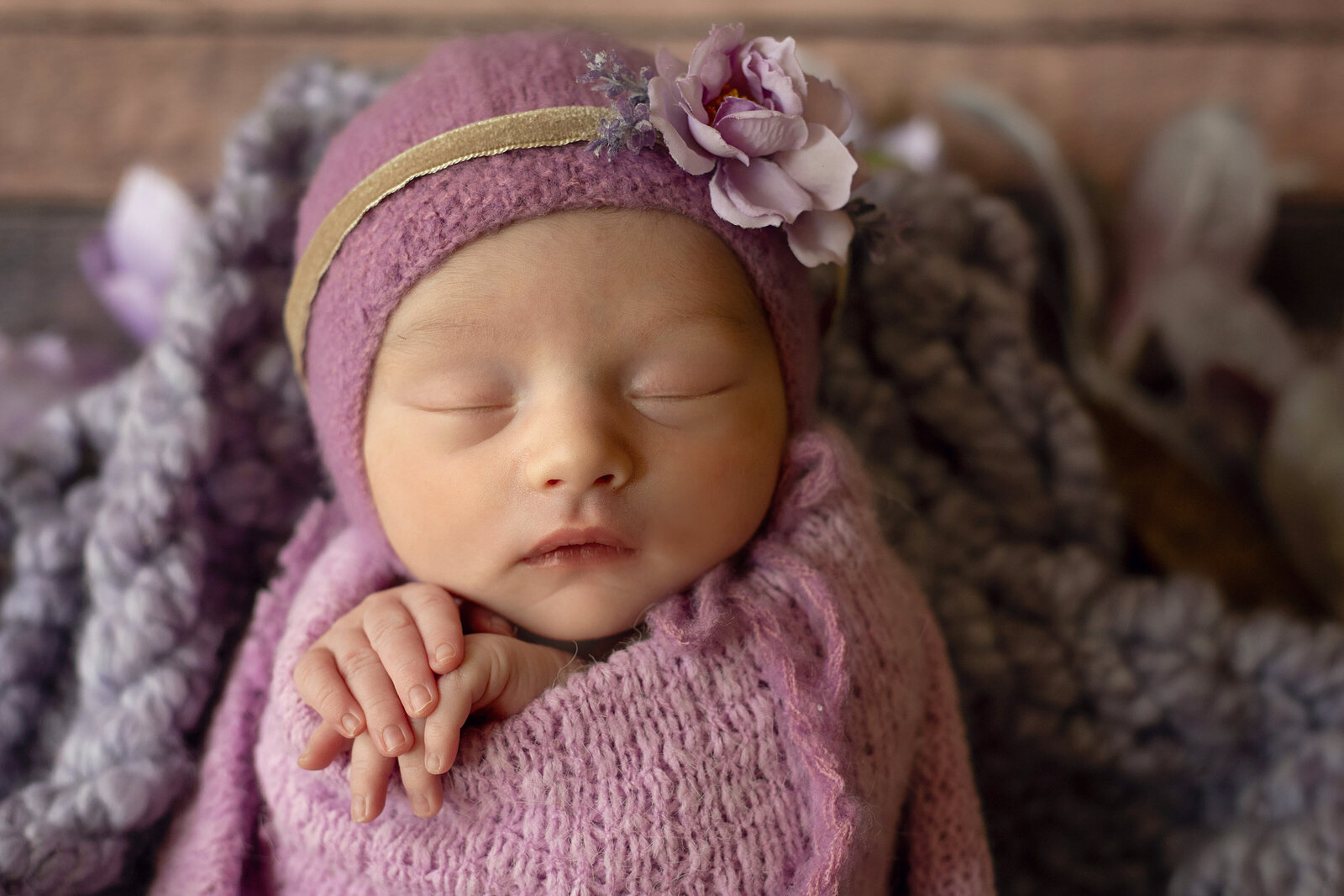 Baby-girl-newborn-session-with-lilac-bonnet