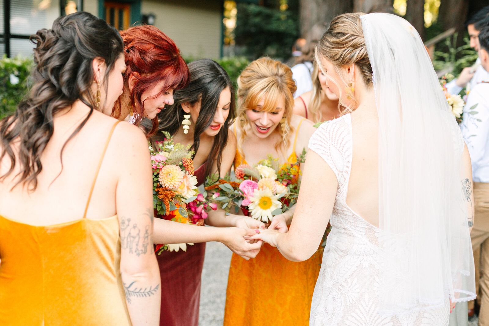 Bride and bridesmaid at her colorful wedding ceremony in Santa Cruz, California in the redwood trees.