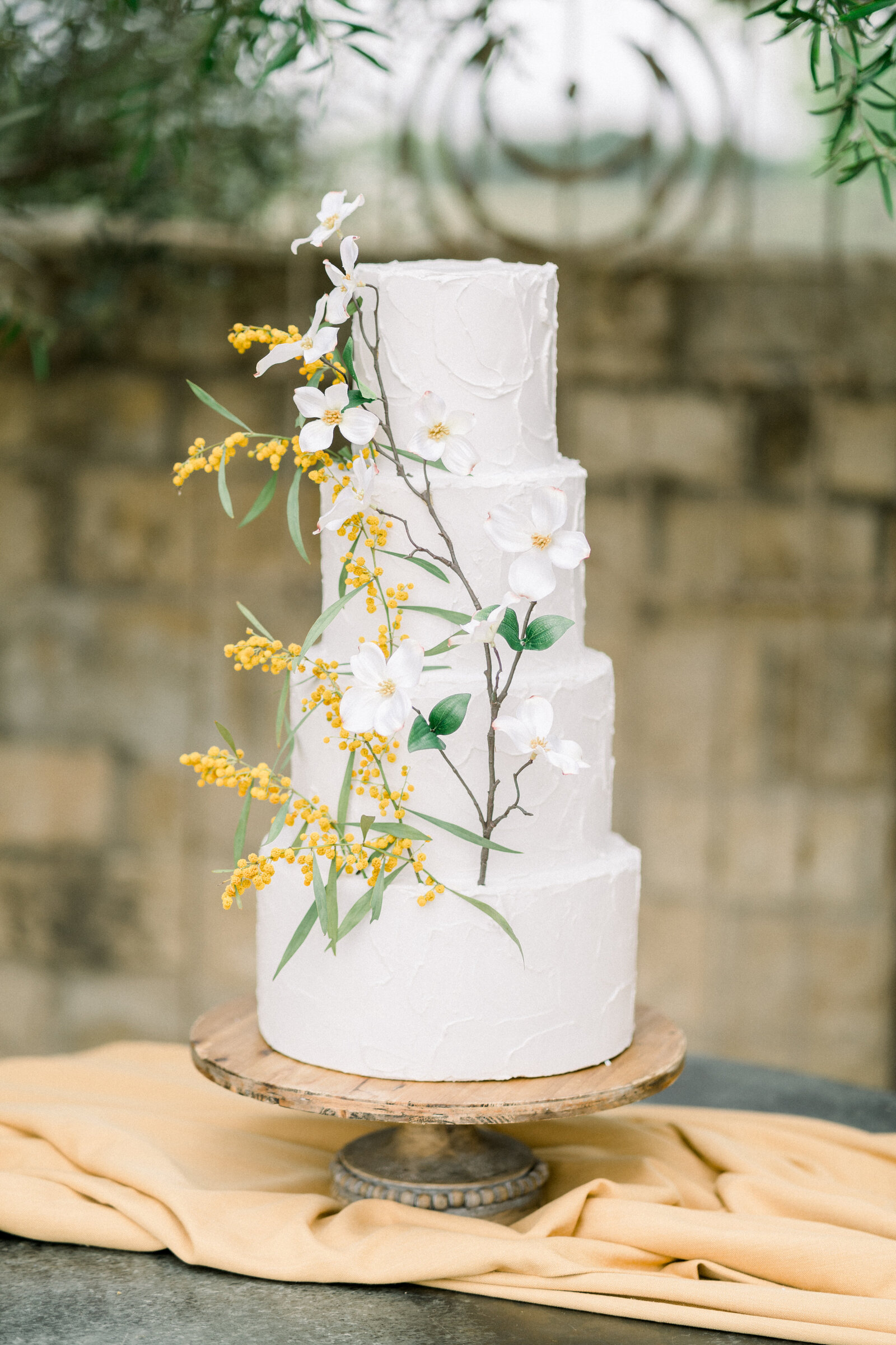 Yellow dogwood flower wedding cake at Sunstone Winery wedding in Santa Ynez, CA