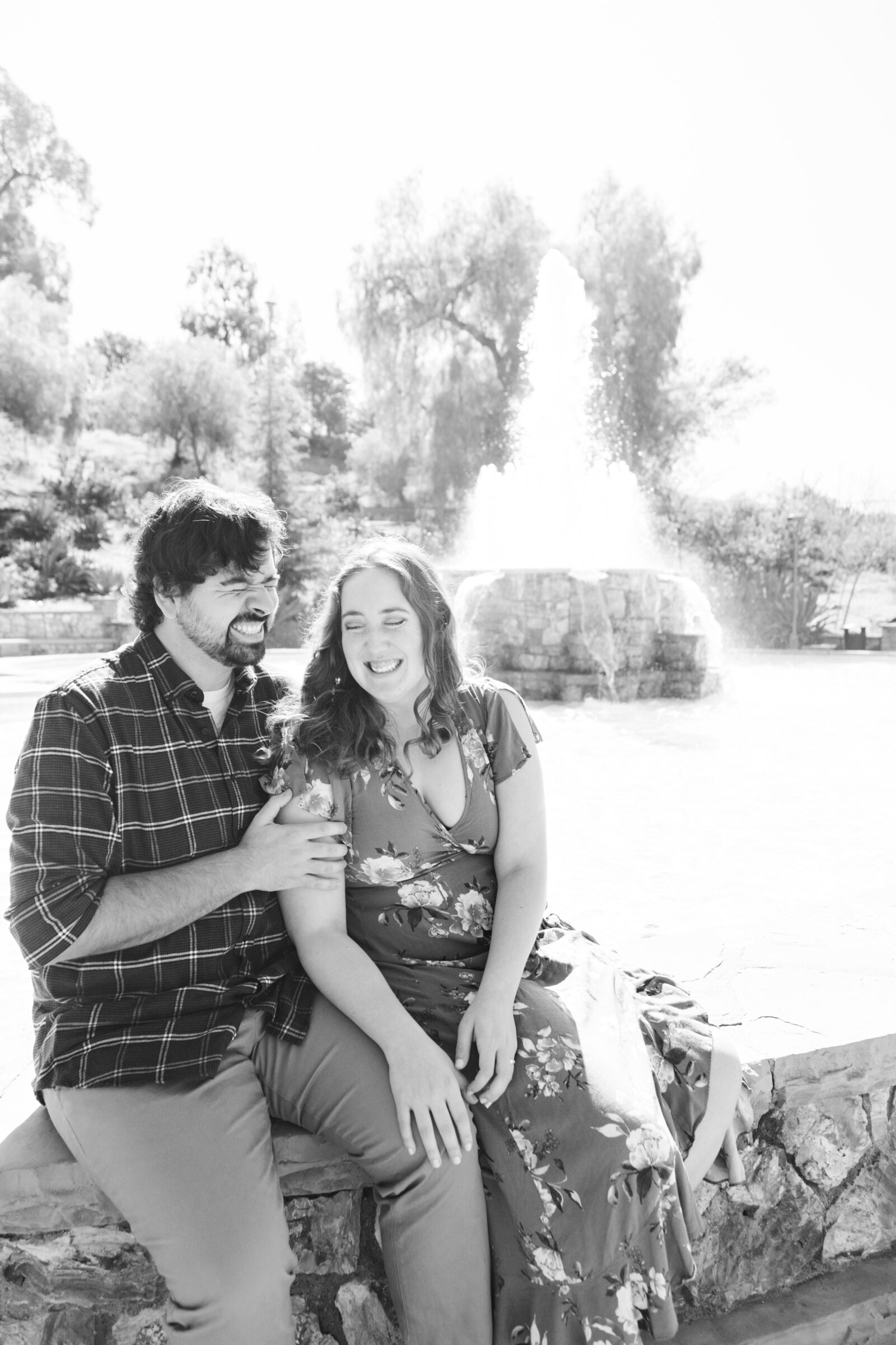 An engaged couple poses for photos in a garden in Los Angeles, Ca.