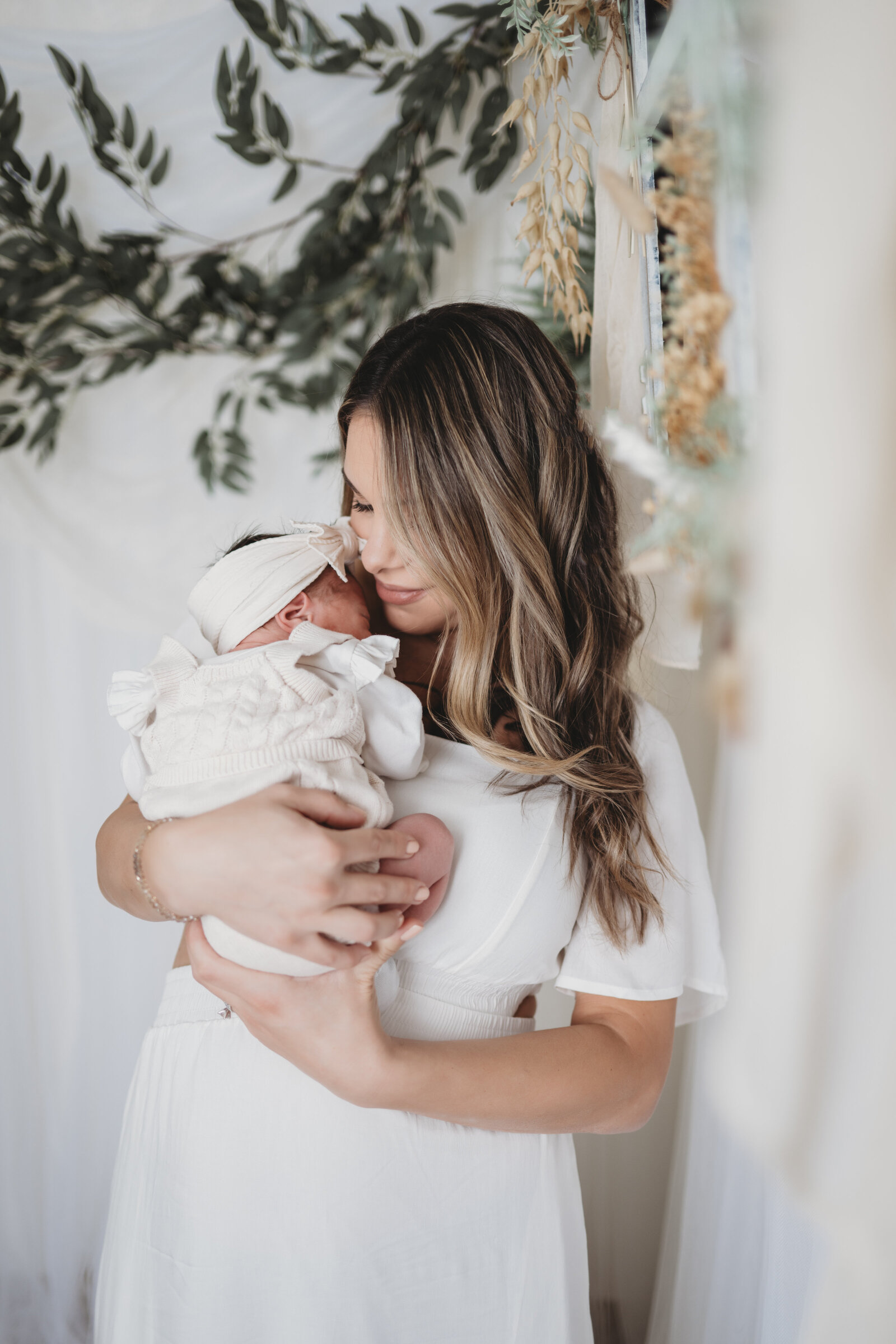 Experience the warmth of motherhood with natural, elegant newborn photography in Connecticut. This intimate moment captures a mother embracing her newborn in a beautifully styled setting, showcasing love, tenderness, and connection. Book a lifestyle newborn session to preserve your baby’s first precious days with soft, organic, and timeless photography.