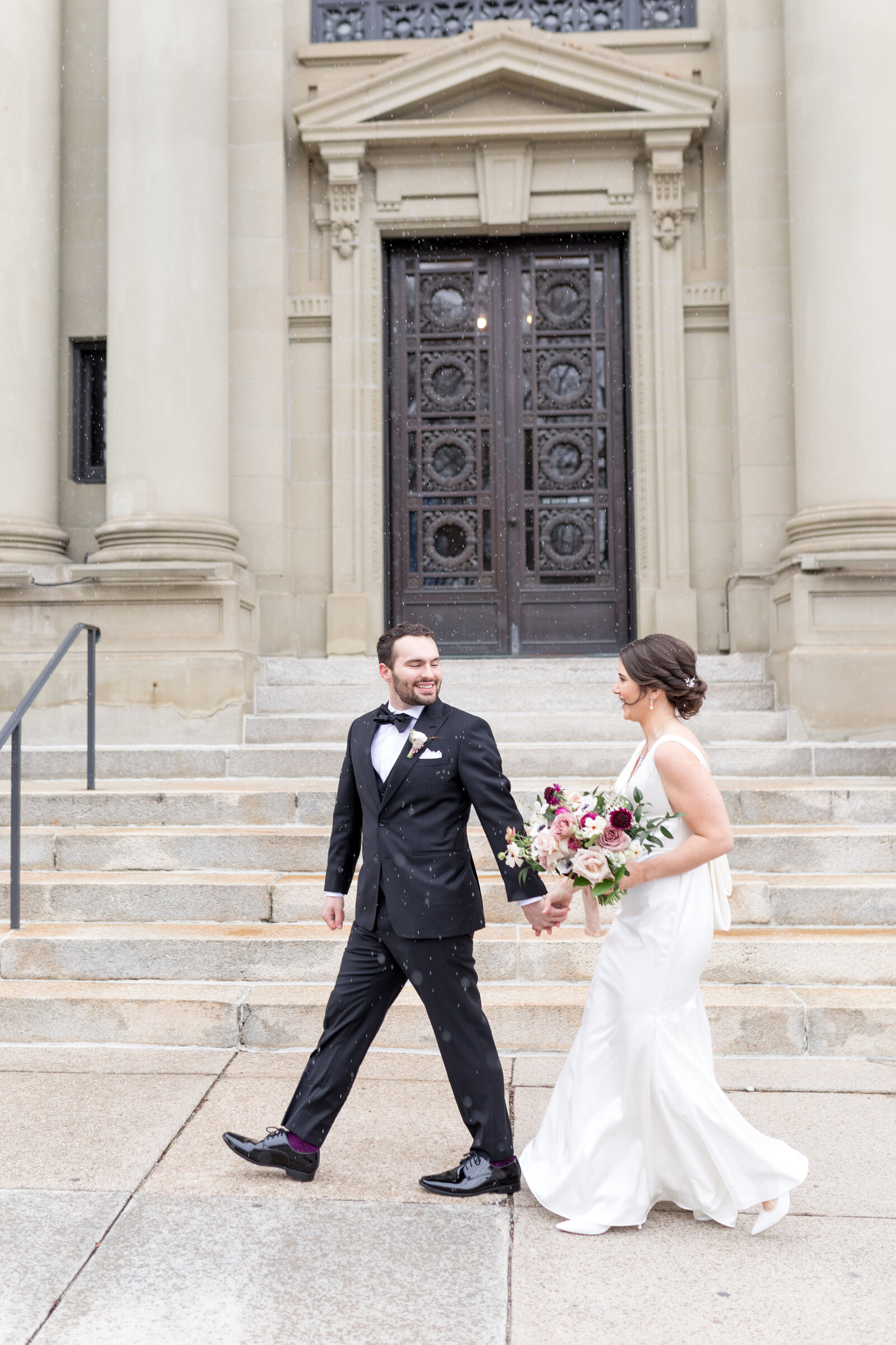 bride and groom walking down street