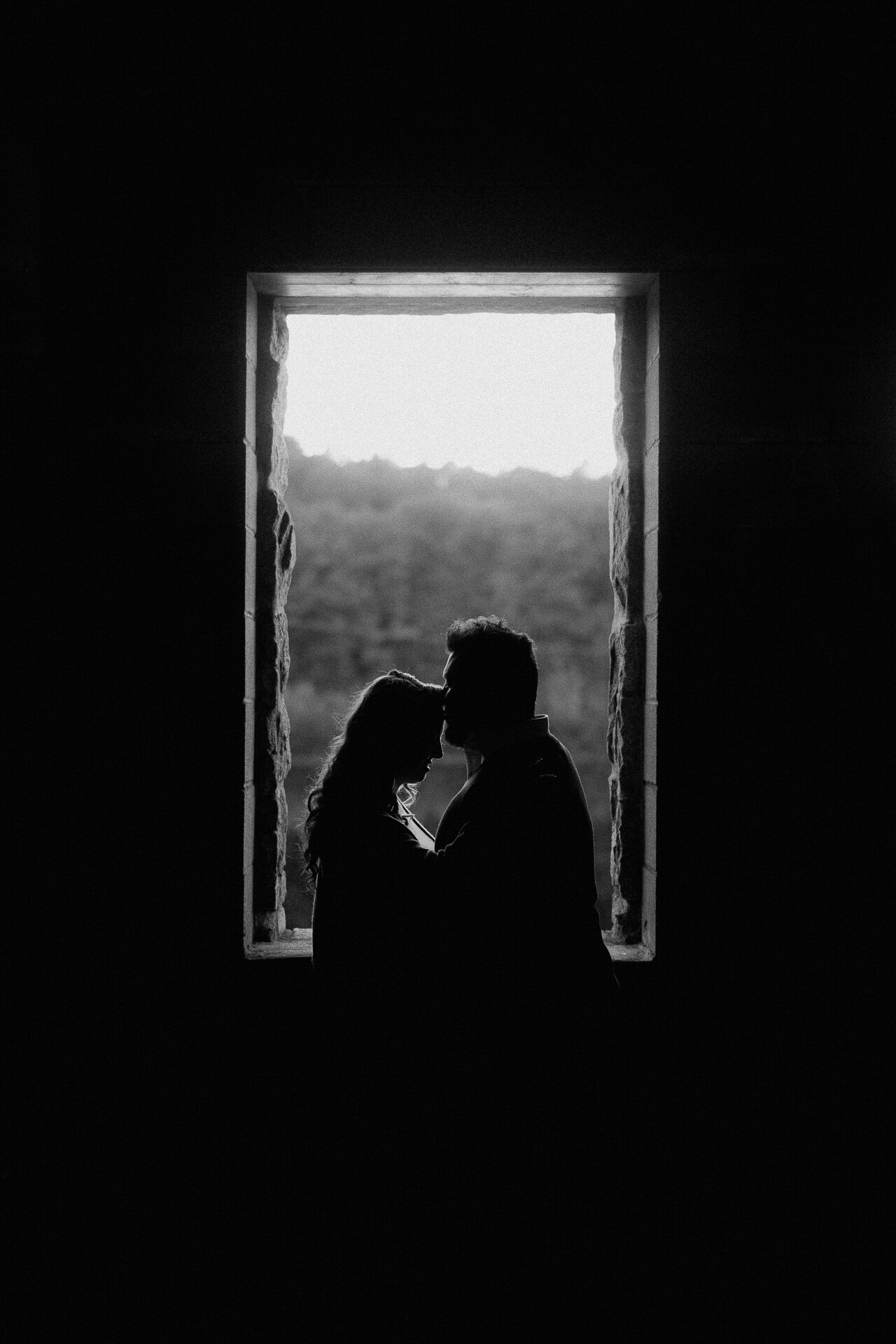 kissing-forehead-silhouette-old-stone-church