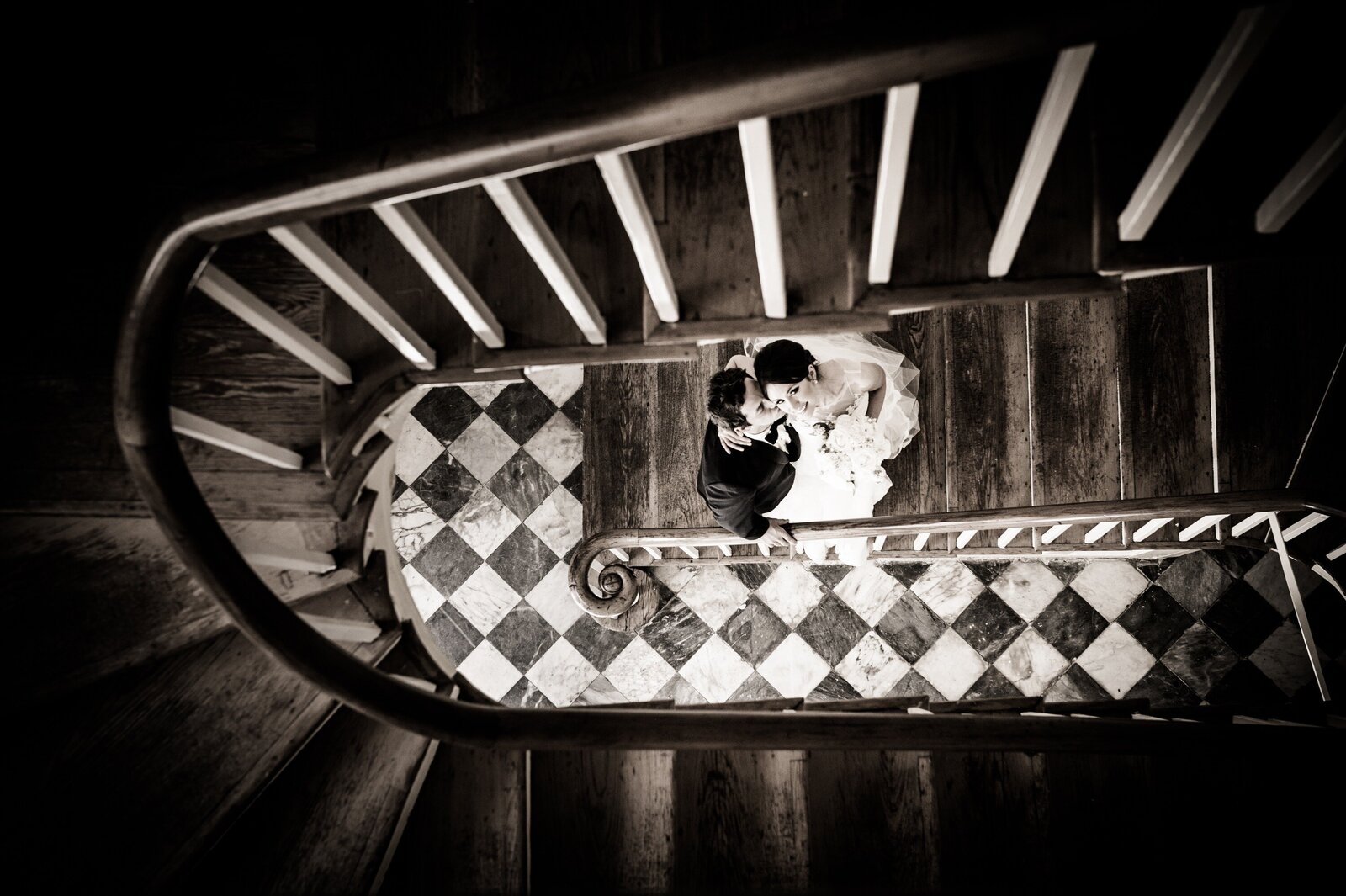 Bride and groom on stairs at Latrobe's on Royal wedding in New Orleans