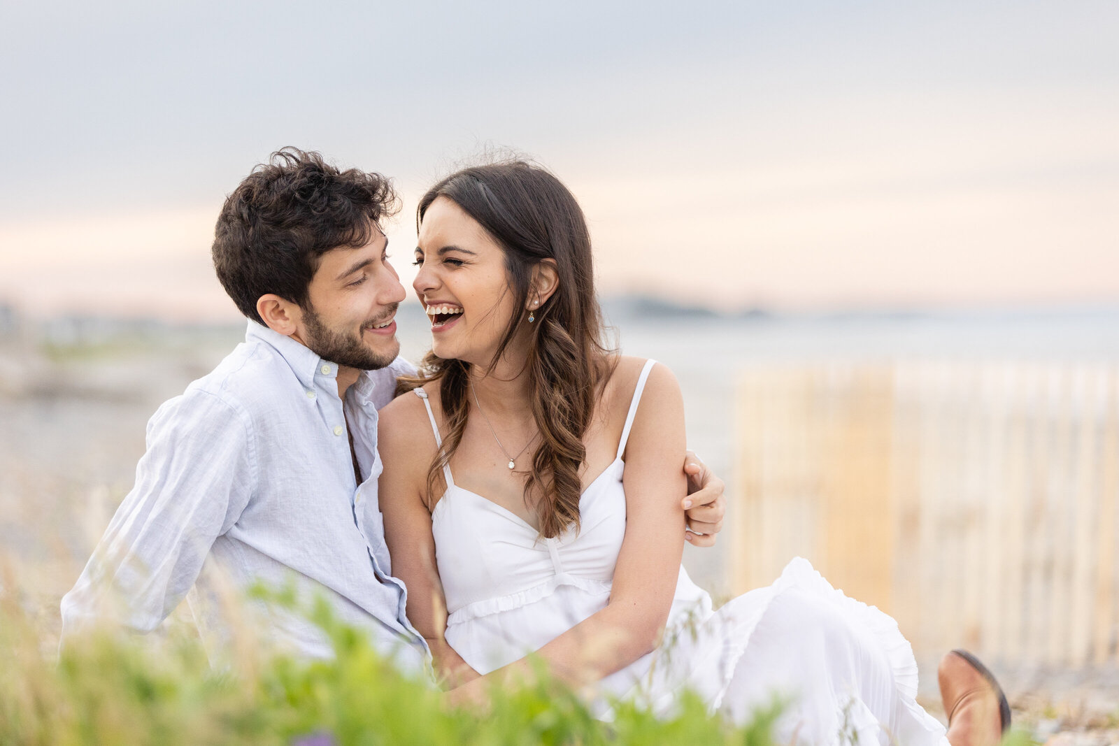 couple laughs-in-beach-grass-engagement-lisa-gilbert-photography