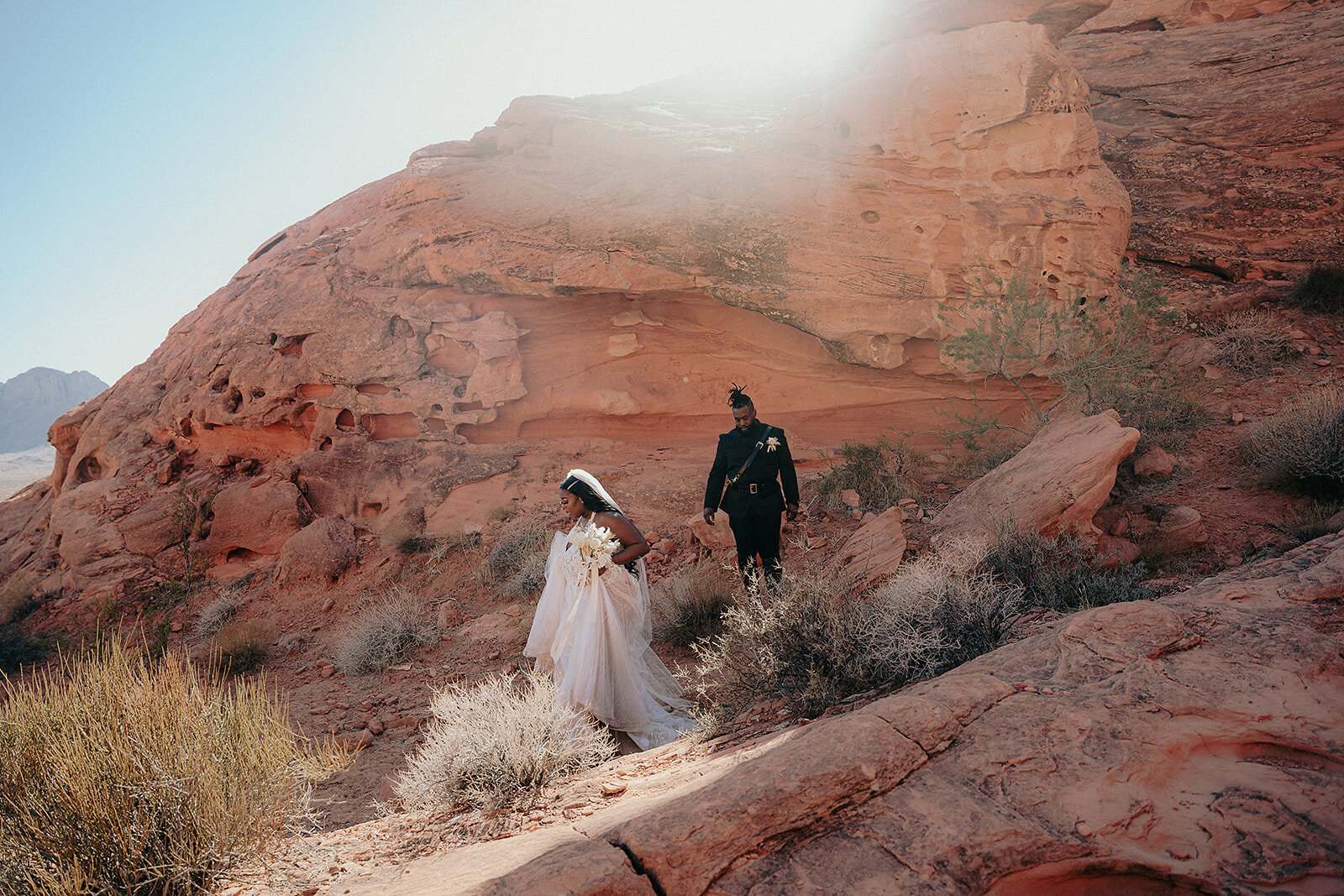 Bride and groom walking through the Valley on Fire in Clark County, Nevada