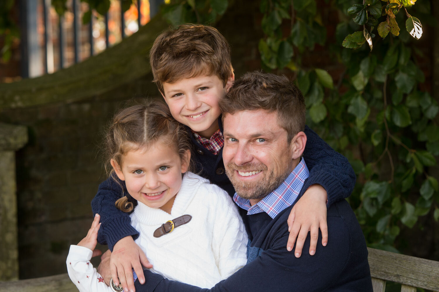 A man and two children are posing for a picture
