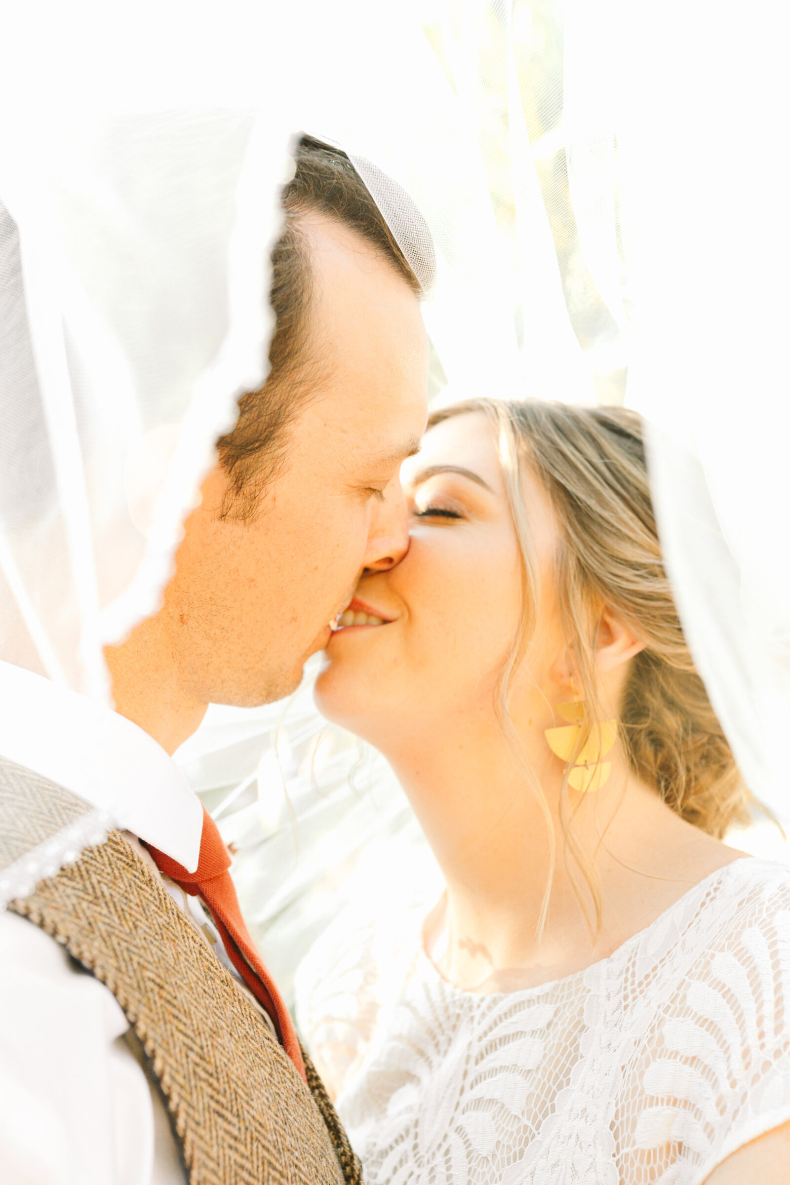 Bride and groom on their colorful wedding day in Santa Cruz, California in the redwood trees.