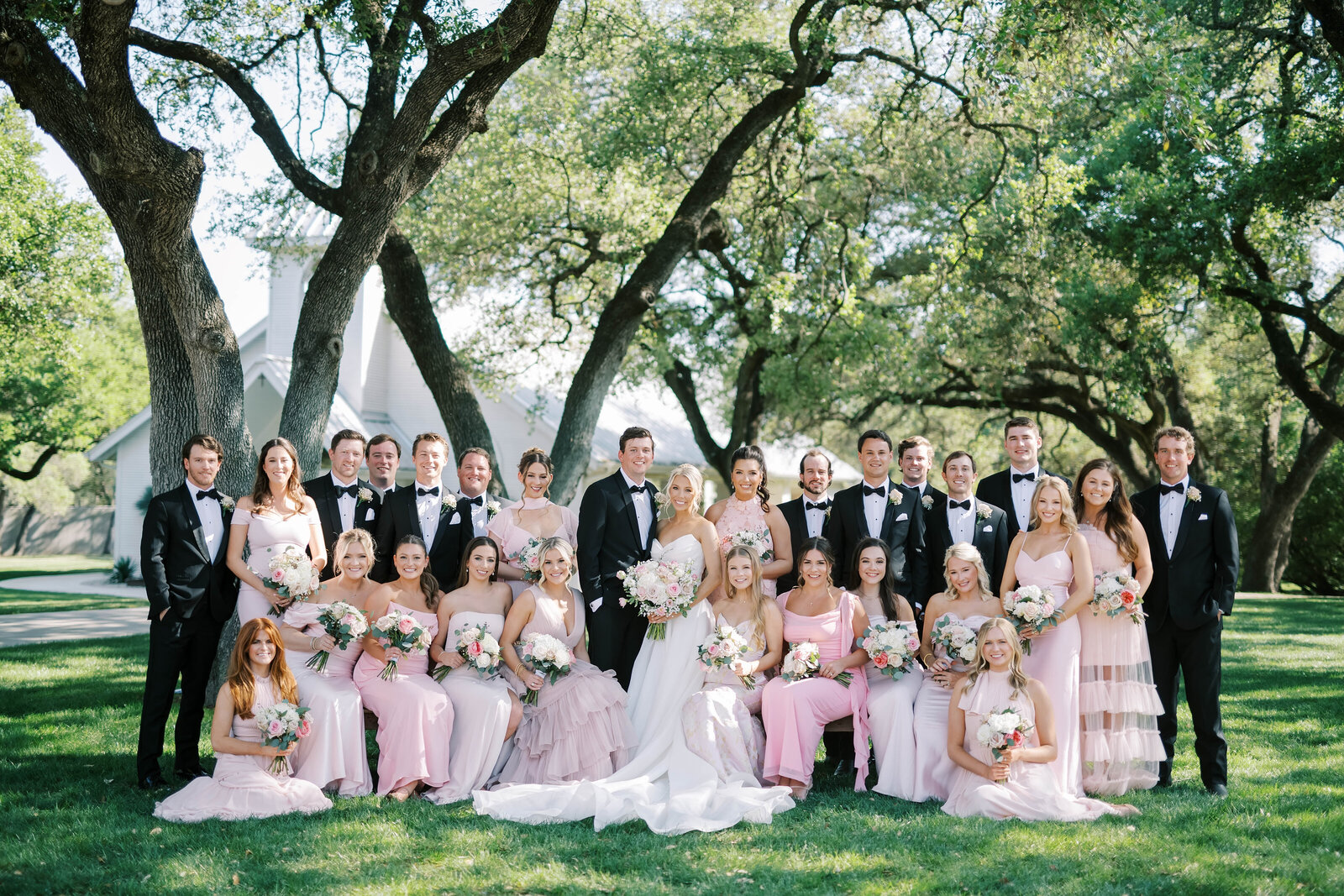 Bride and groom walk arm in arm and smile on their wedding day at the Springs Wallisville