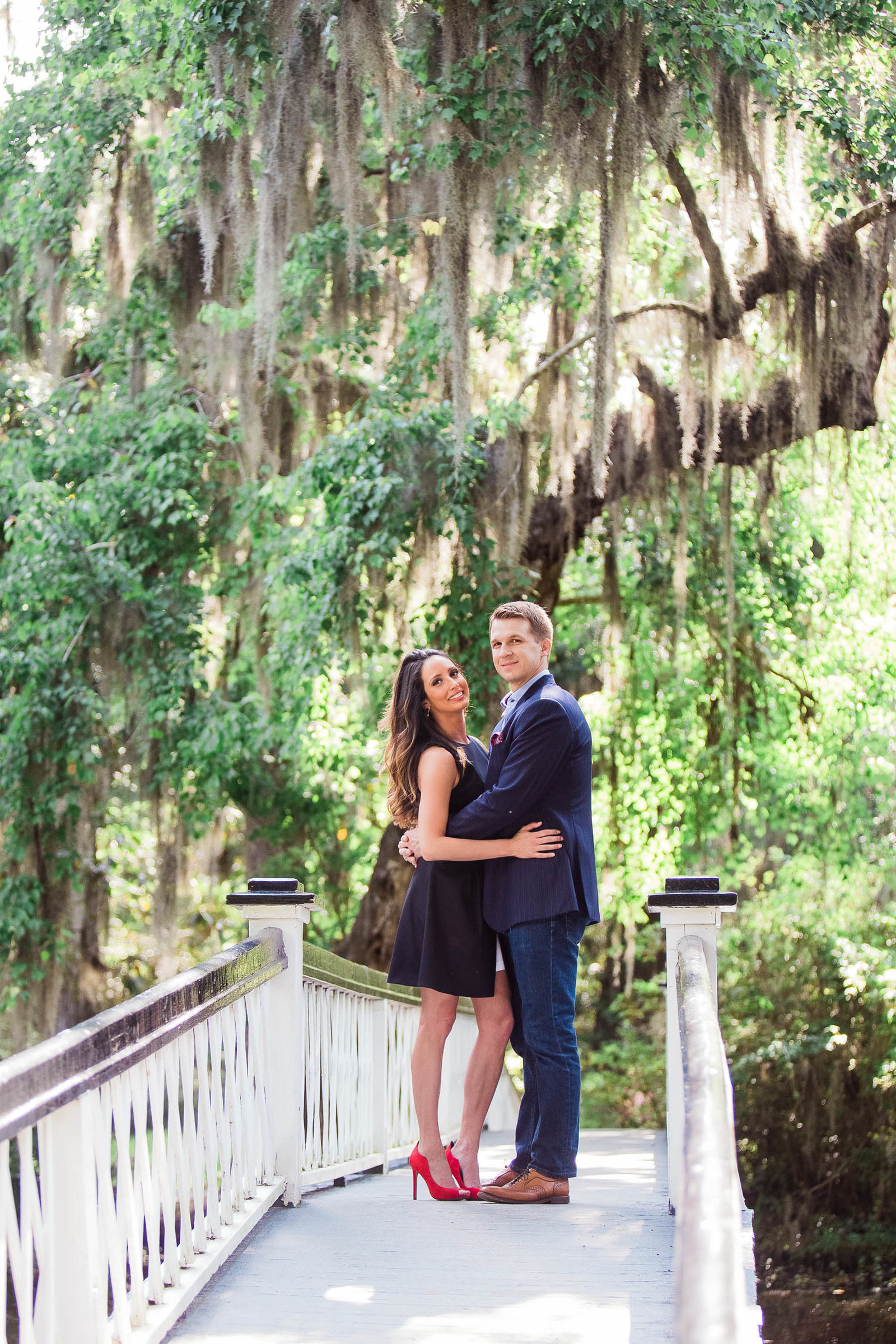 Engaged couple stand on a white bridge, Magnolia Plantation, Charleston, South Carolina