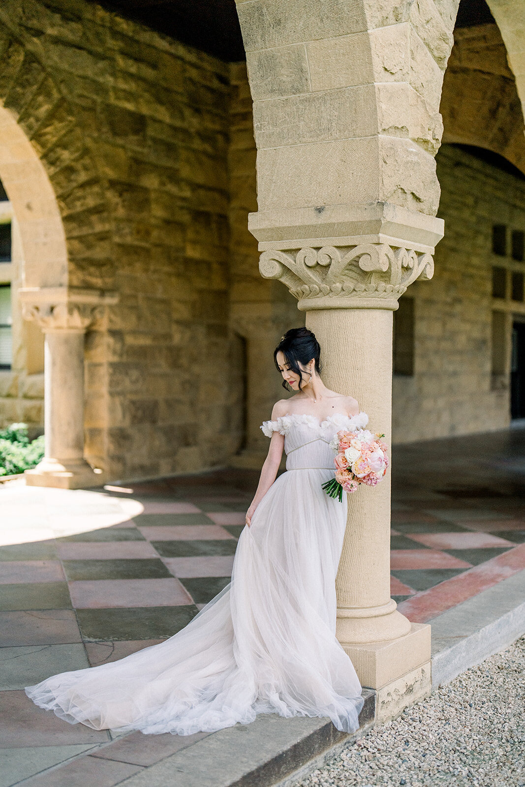 A beautiful bride elegantly poses at Stanford University, capturing the timeless beauty of her wedding day in California.