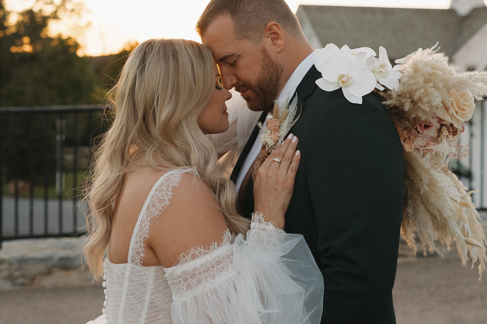 Bride and groom close together in the golden evening light