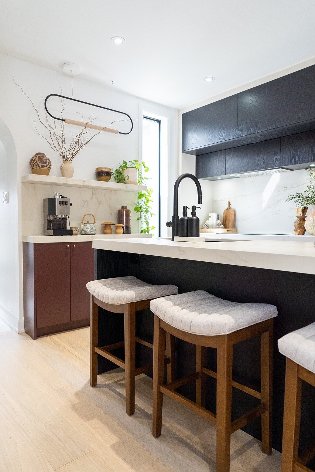 Modern kitchen island with stools and elevated home decor