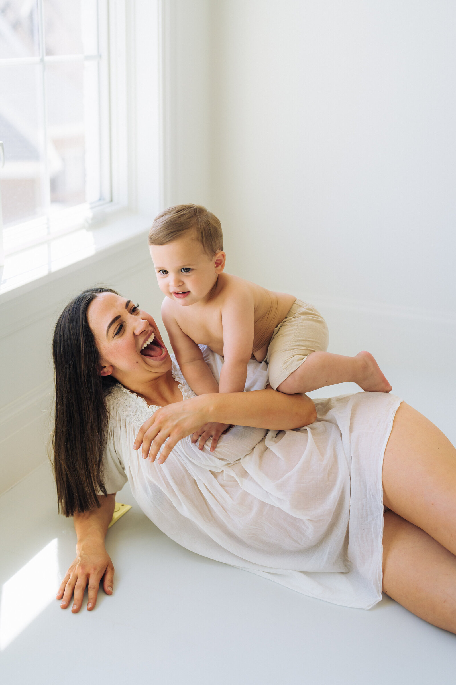 mom and little boy laughing in a st. louis studio