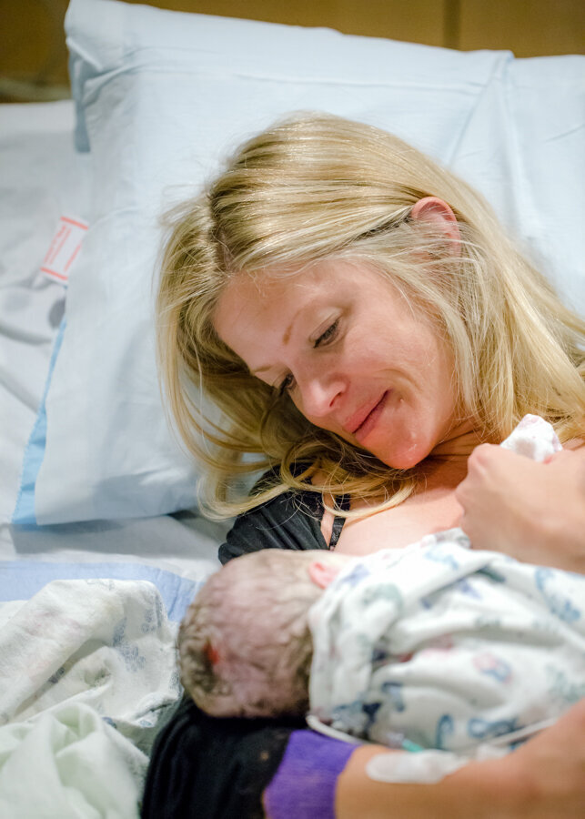 A mother gazes at her newborn baby. Birth story by Diane Owen Photography.