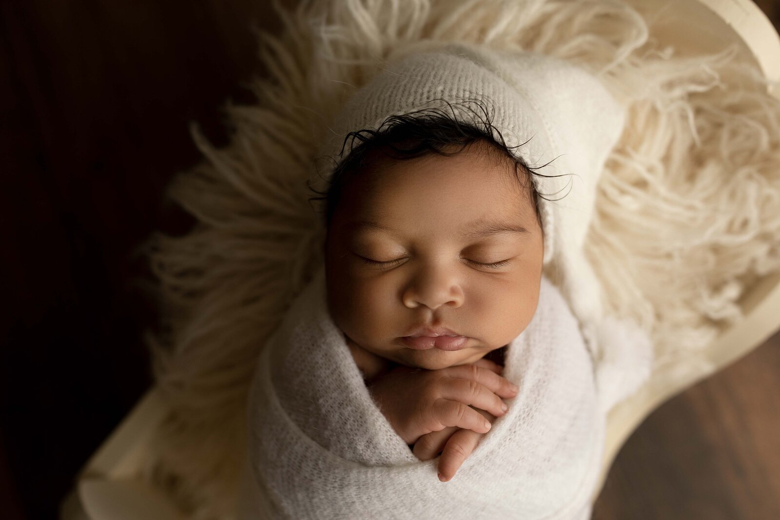 Ogg Photography London, Ontario Newborn Photographer Speeking Baby in Cream Wrap and Cap