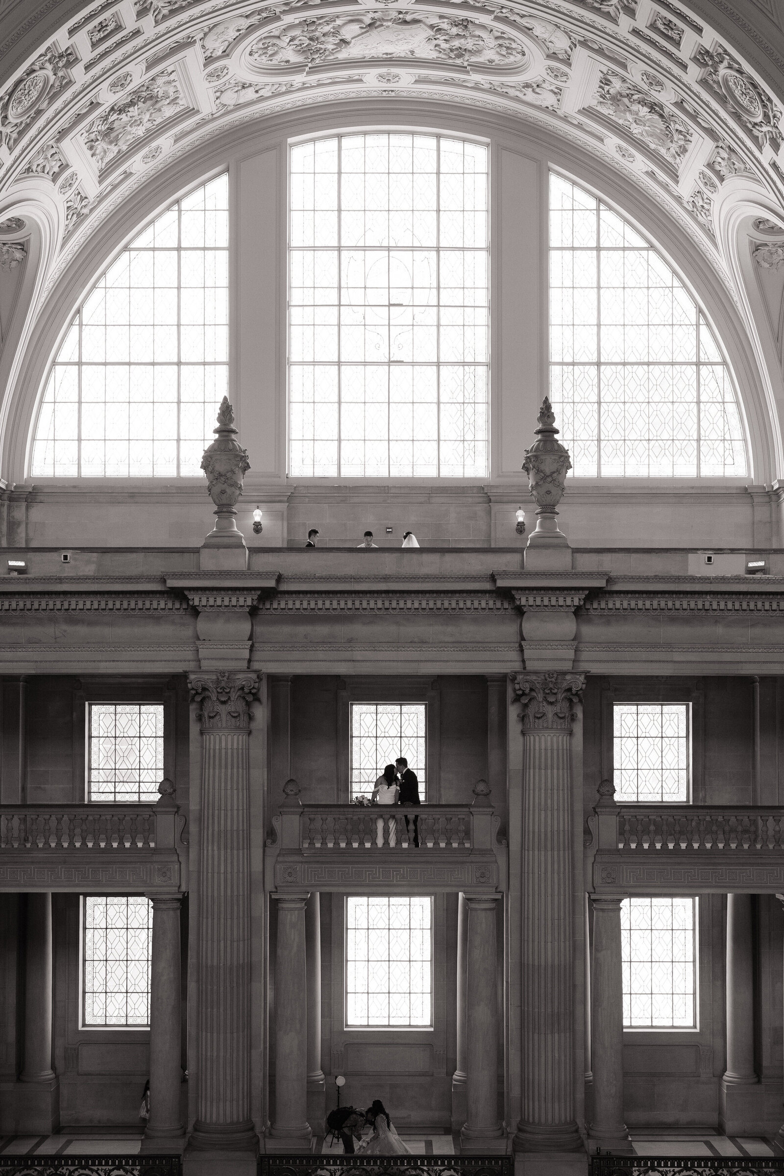 Bride and groom embrace across balcony taken by best Northern California wedding photographers