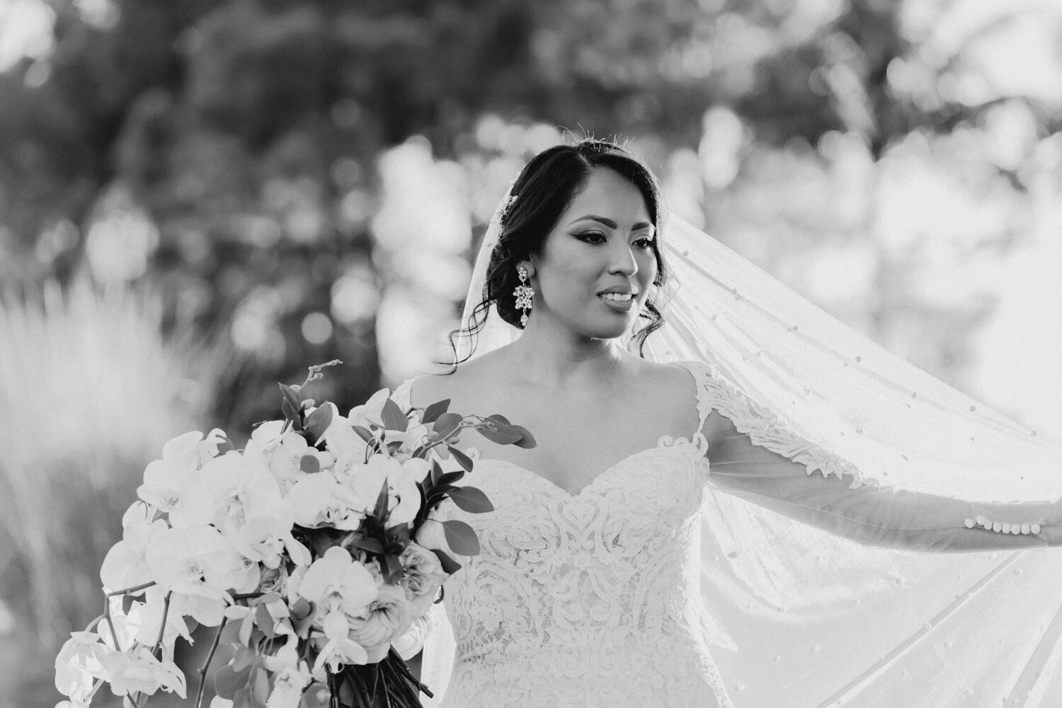 Black and white photo of bride holding floral bouquet