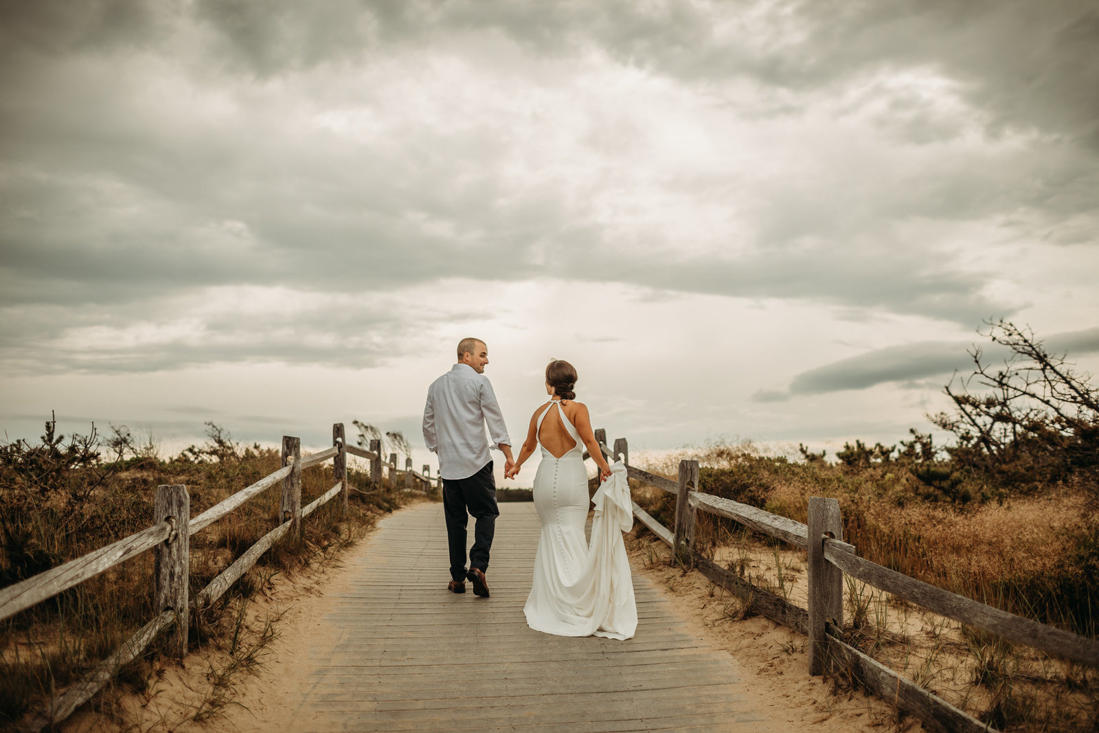 couple walks hand in hand after cape cod elopement