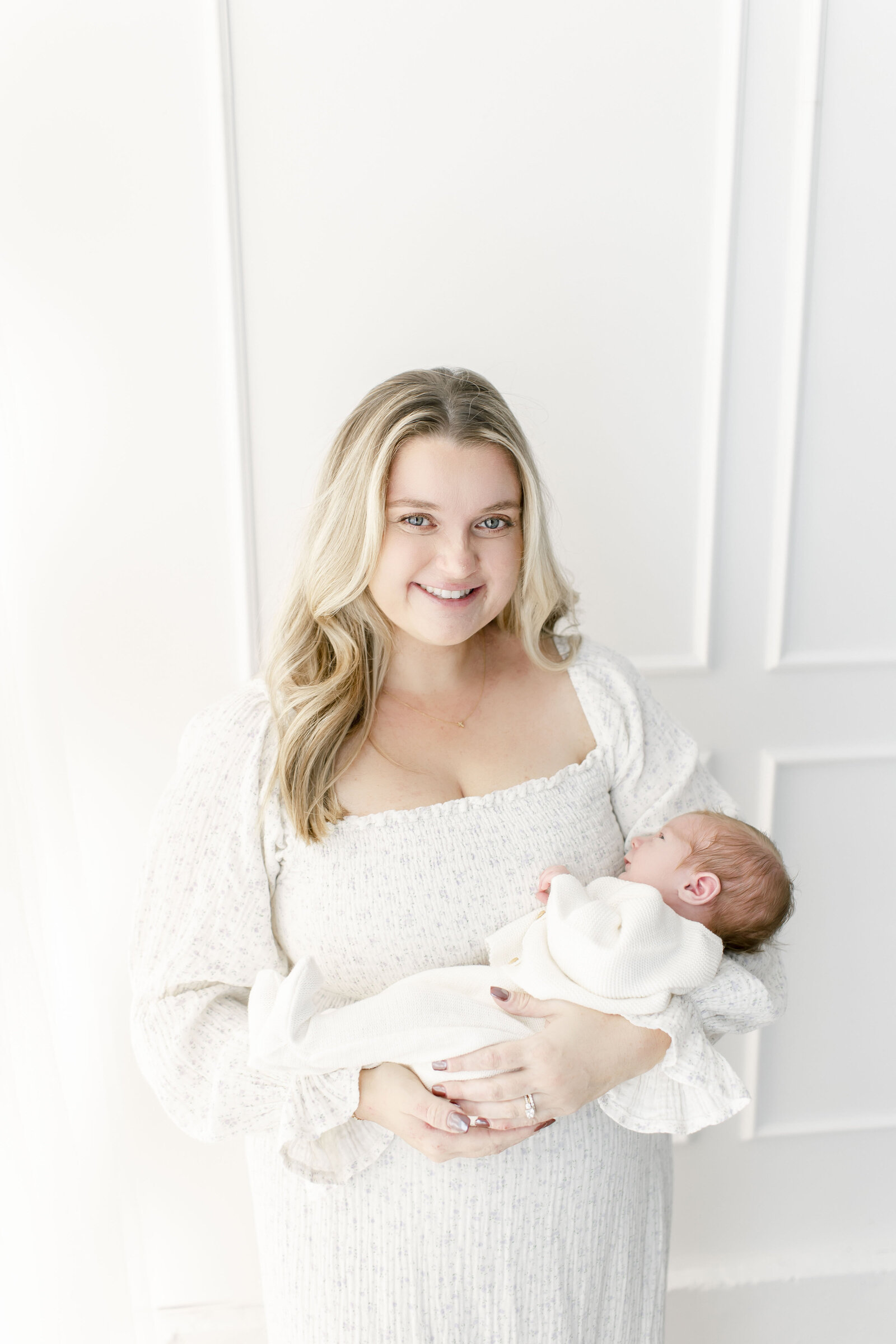 mom holding newborn baby taken by best new jersey newborn photographer ally kimpton