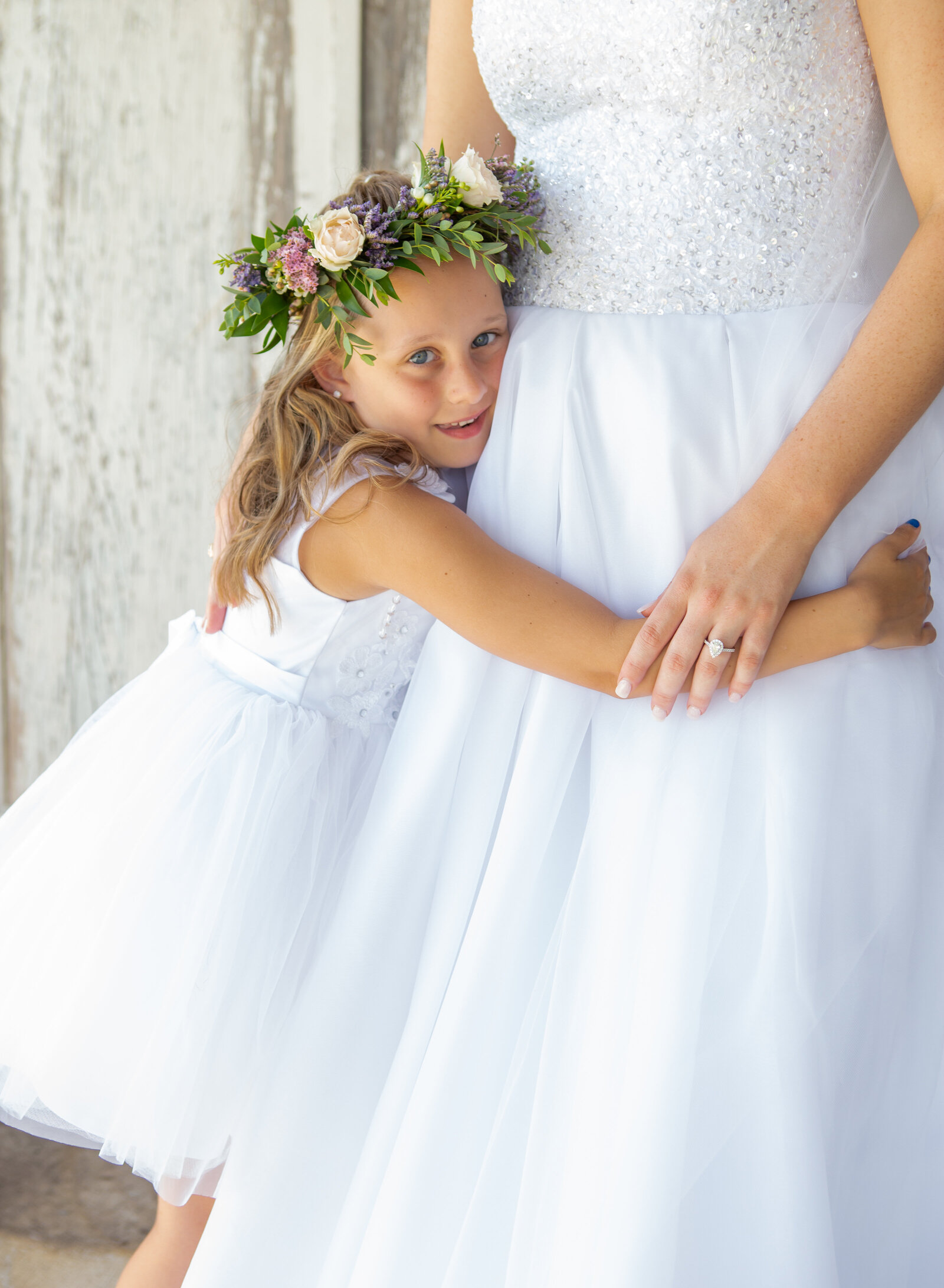 flower girl hugging bride