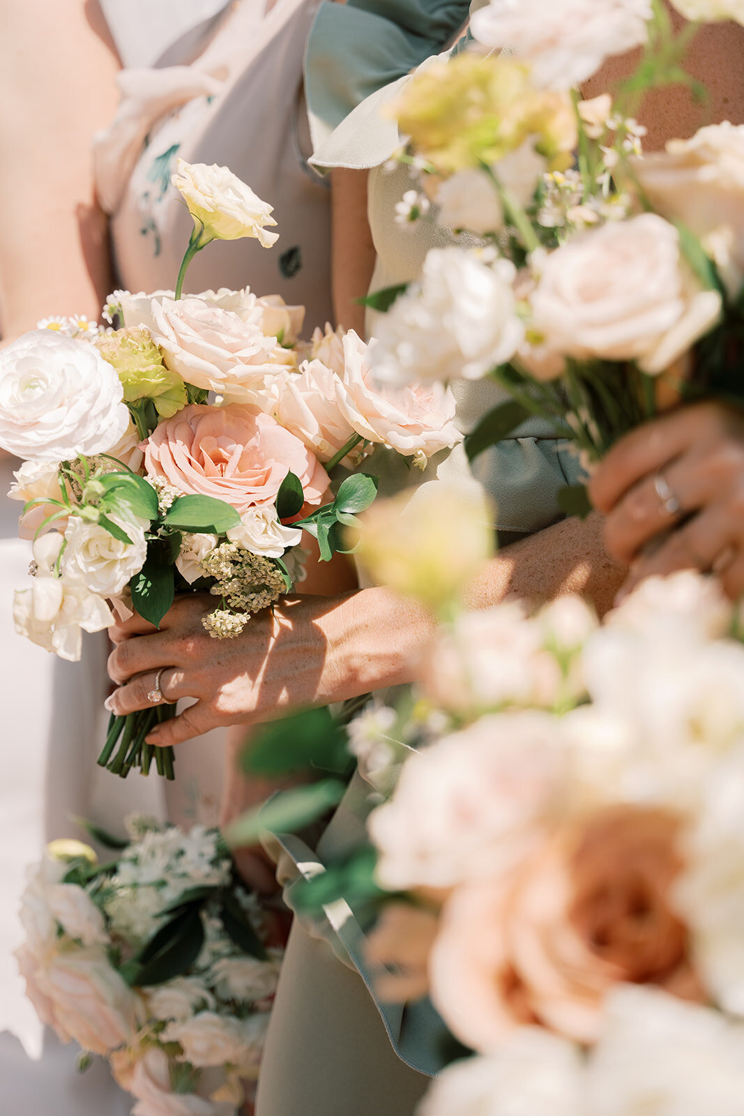 Bridesmaid’s bouquets with peach and blush garden roses, ranunculus and lisianthus.