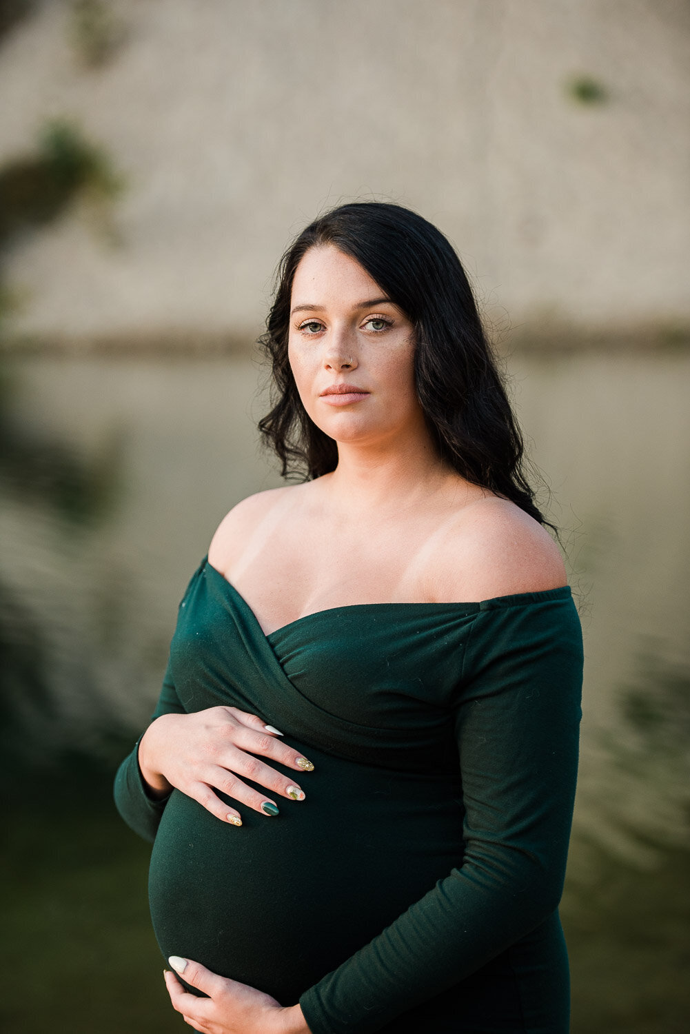 maternity holding belly by water