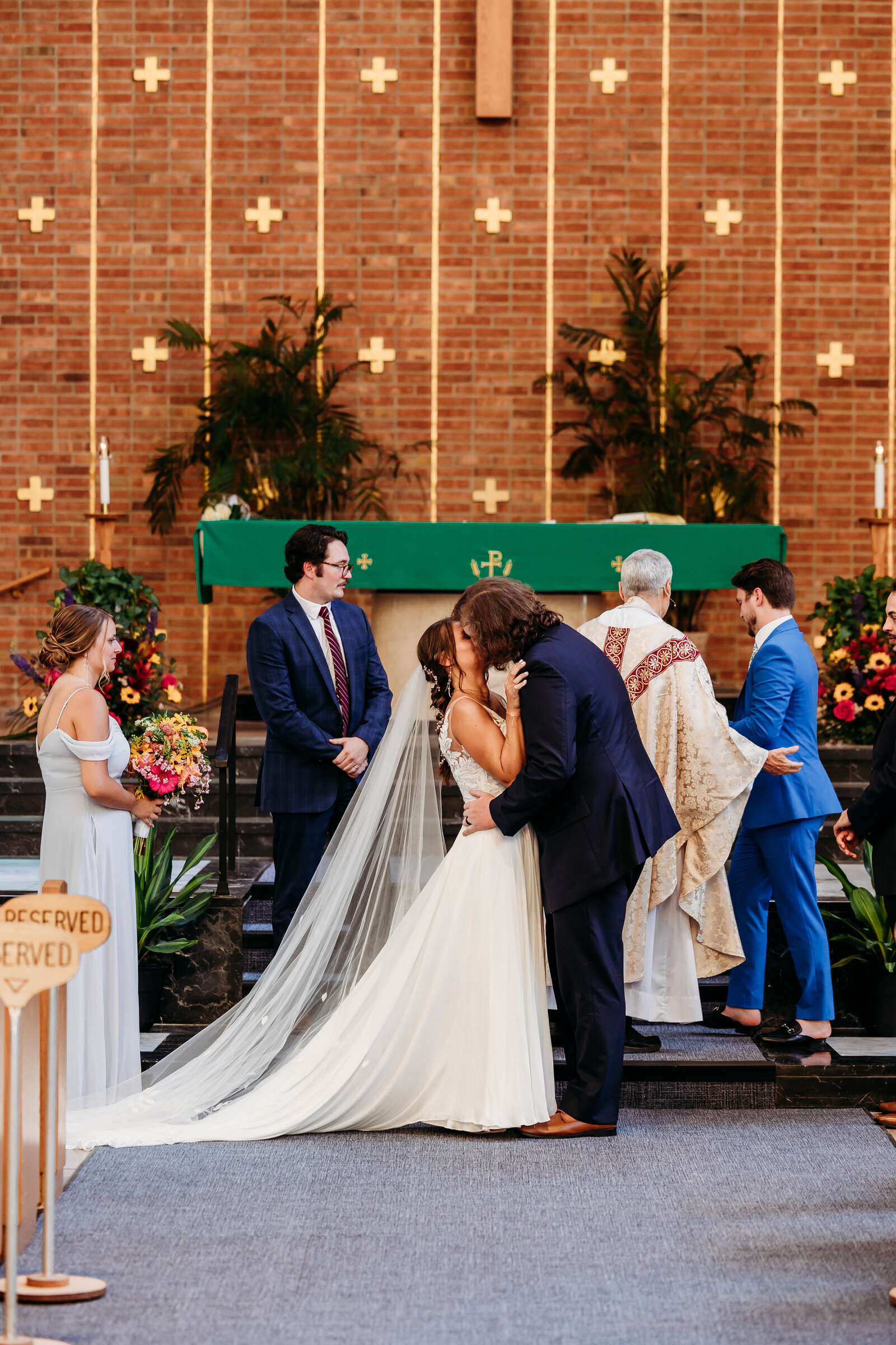 The bride and groom share their first kiss during there wedding ceremony at St. Luke's church