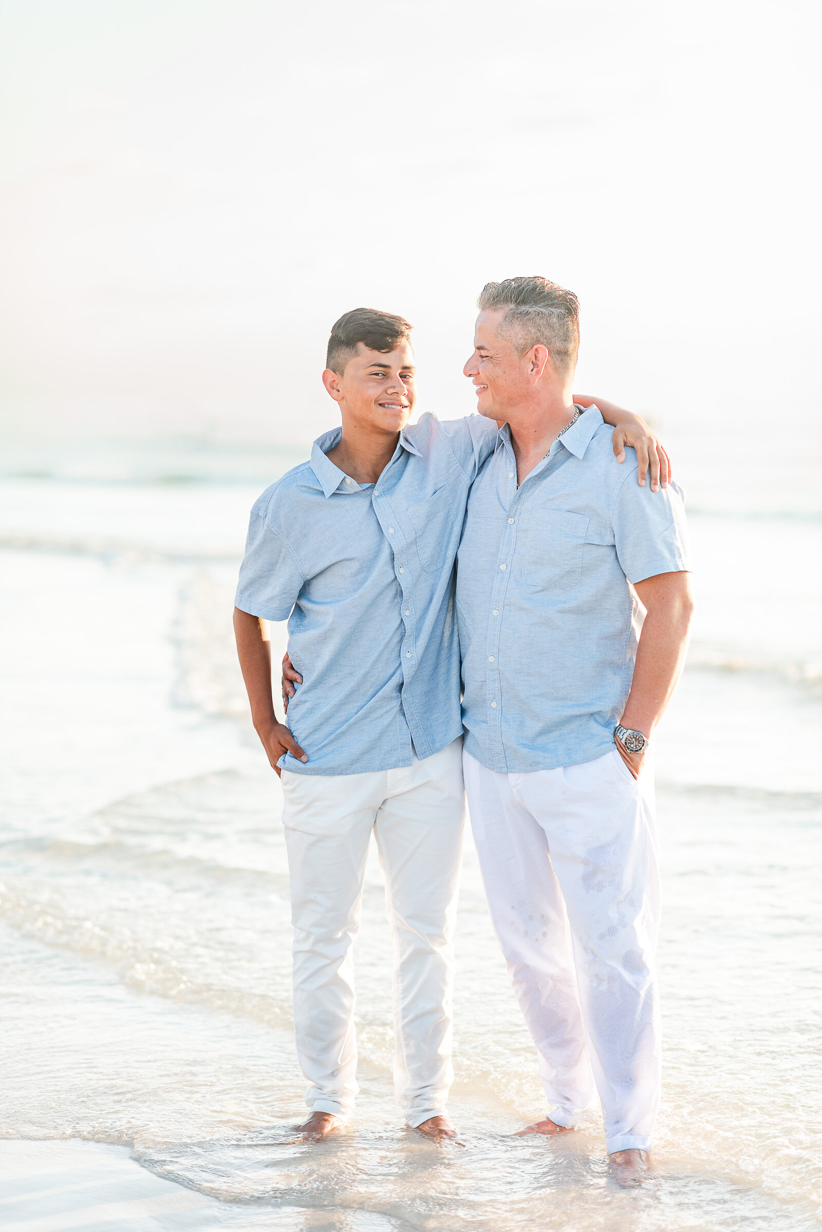 dad and teenage son walking on the beach family session by Miami lifestyle  photographers David and Meivys MSP Photography