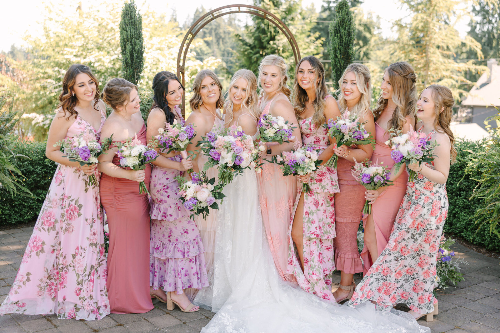 Bridesmaids in floral dresses standing together in a garden in oklahoma city