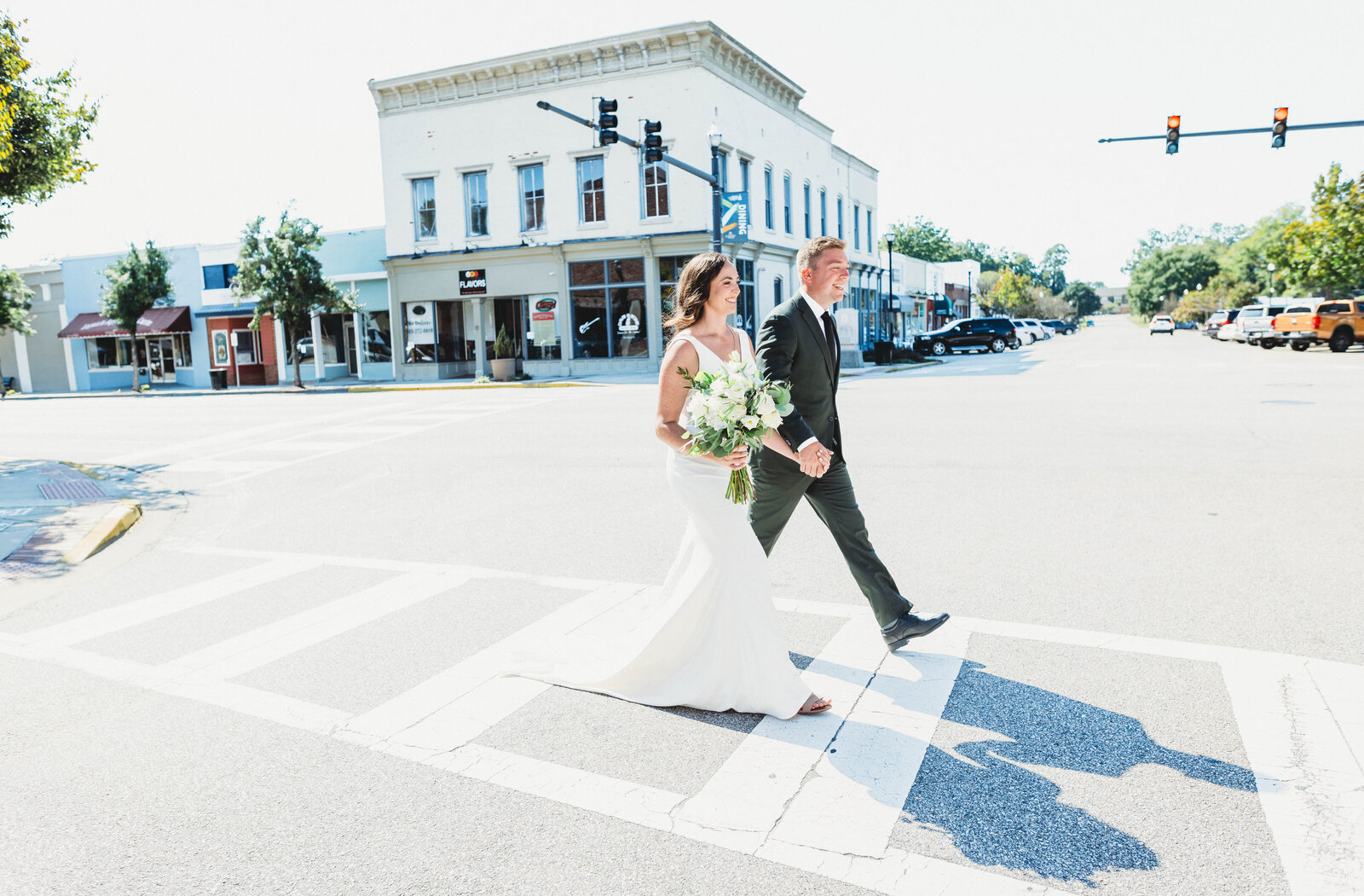 Couple walking the crosswalk for their first look as a destination photographer