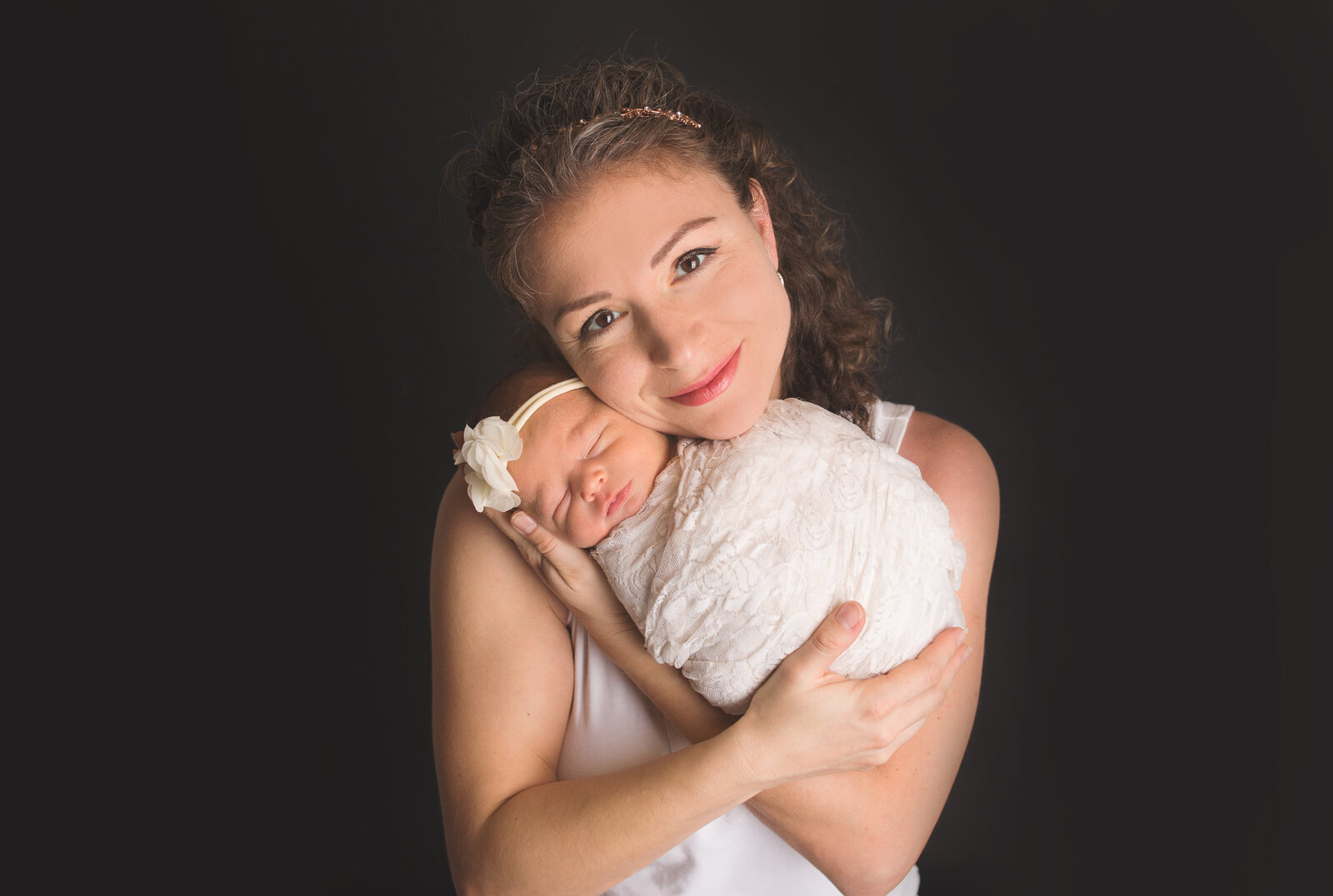 Mom holding baby girl wrapped in lace during newborn photoshoot with Nashville, TN photographer