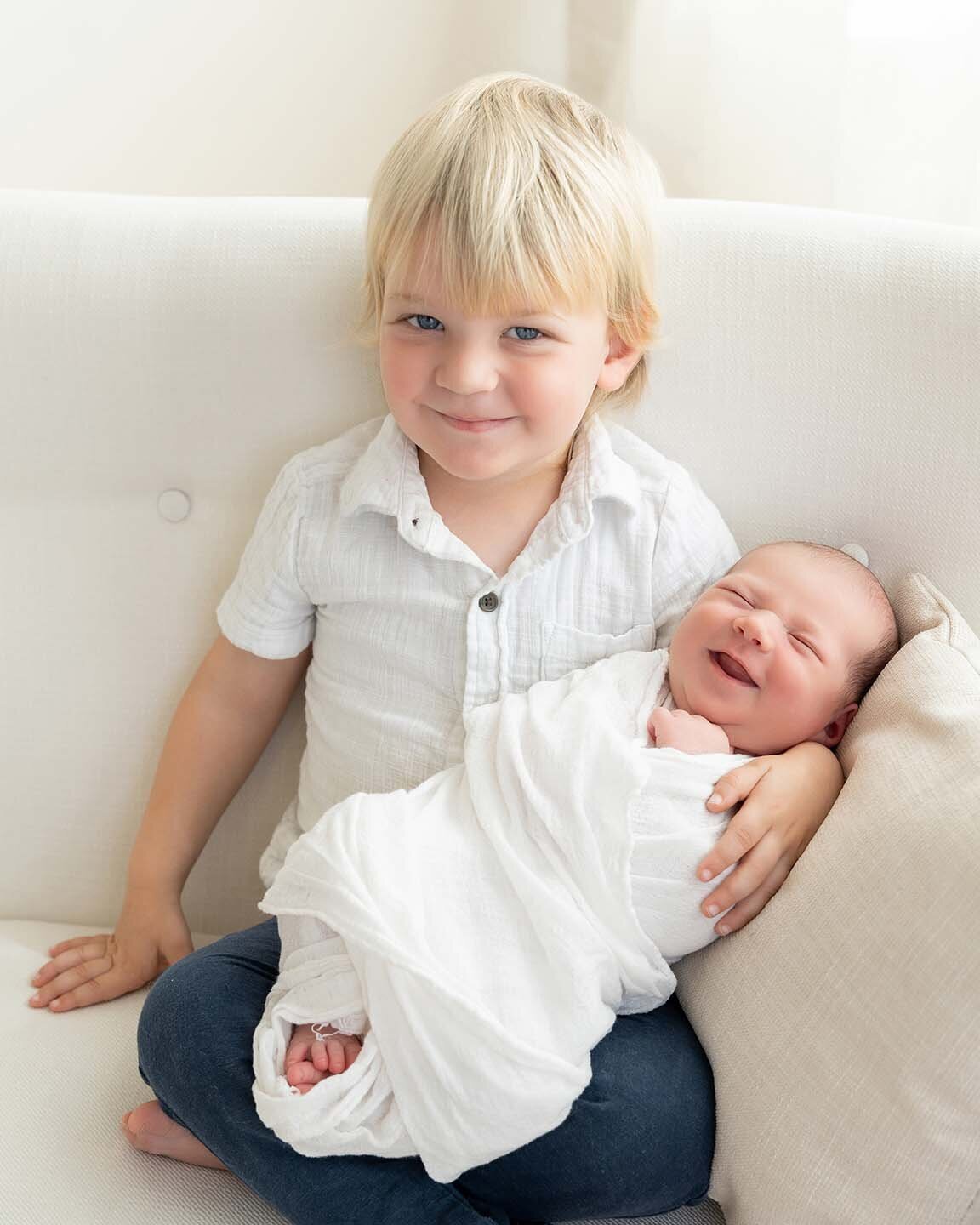 little-boy-holding-smiling-newborn