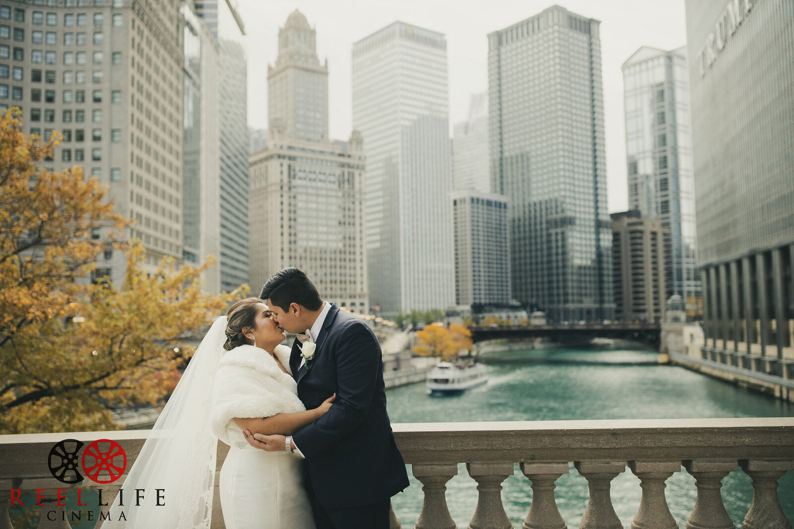bride and groom standing on bridge in chicago