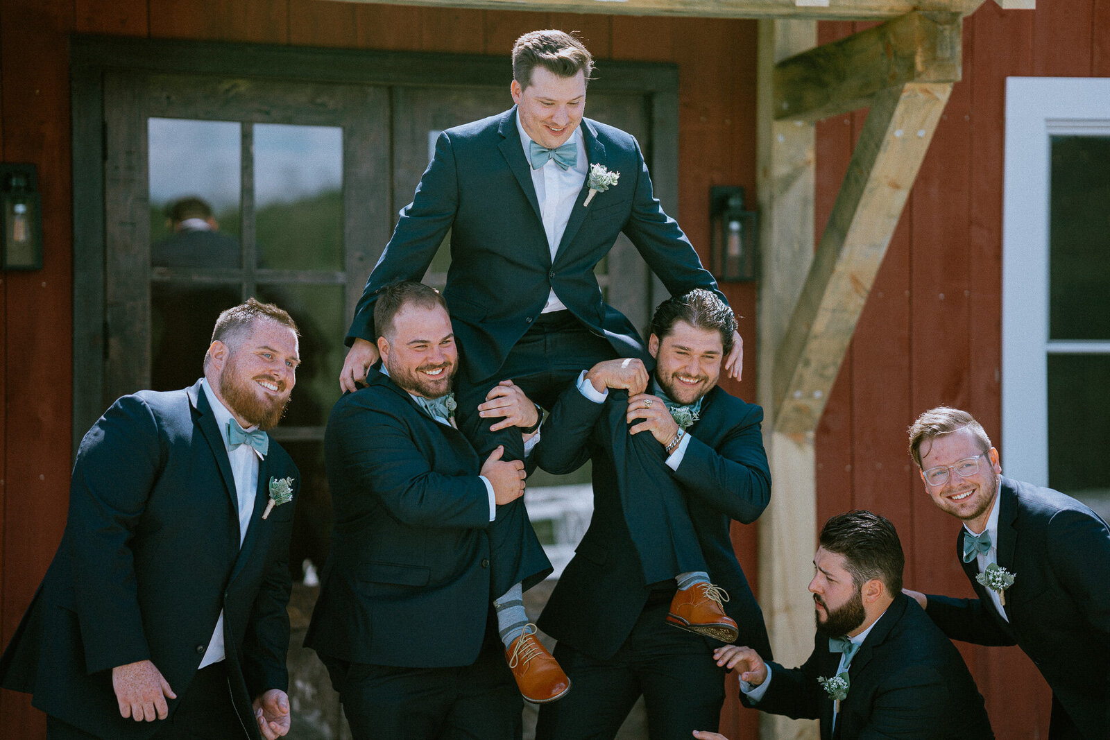 groomsmen-lifting-groom-formals