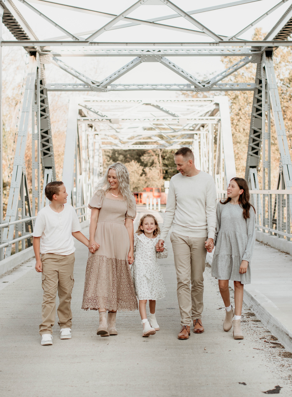 Family walking on bridge. 