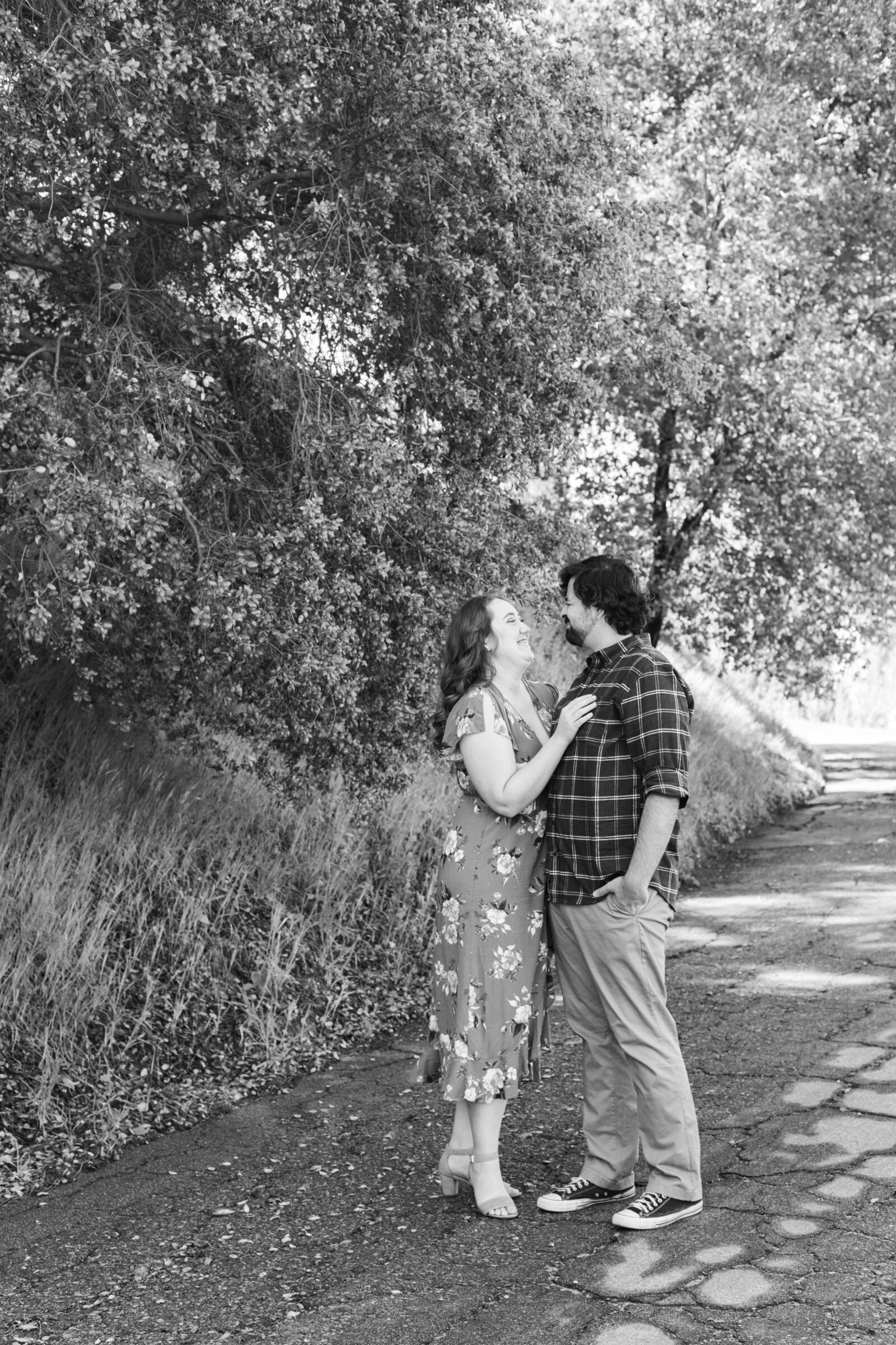 An engaged couple poses for photos in a garden in Los Angeles, Ca.