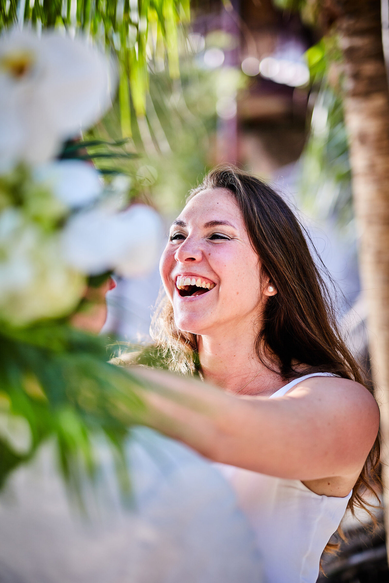 Bride laughing on beach wedding