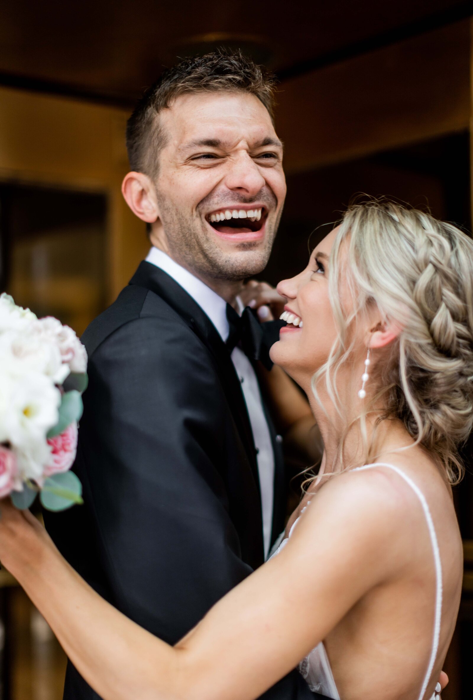 Capture the essence of pure joy in this vibrant photo of Hailey and Peter celebrating their special day at The Renaissance Hotel. Their faces radiate happiness and energy as they share a laugh, perfectly encapsulating the excitement of their wedding day. The grandeur of The Renaissance Hotel adds a touch of elegance to the background, enhancing the festive atmosphere. This image is perfect for couples looking for inspiration on how to create unforgettable, joyful moments on their wedding day, and is ideal for features in bridal magazines, wedding blogs, and social media showcases.