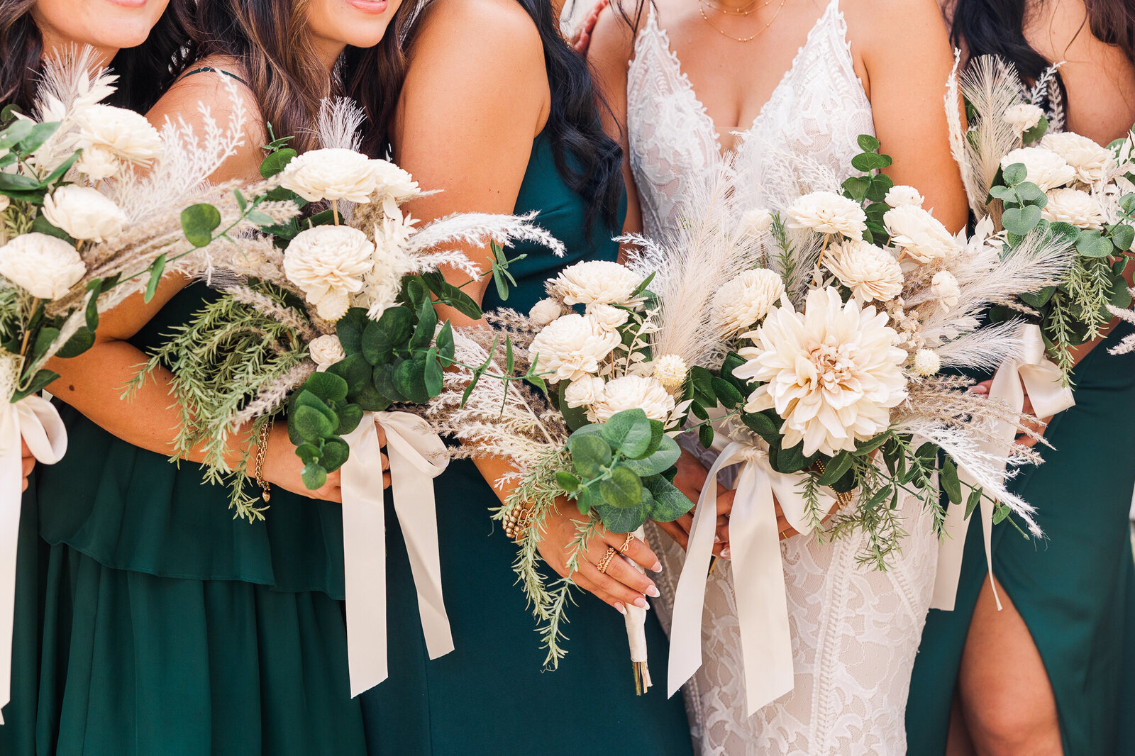Close up image of bridal bouquets in white and hunter green before Wedding at the Red Earth Venue