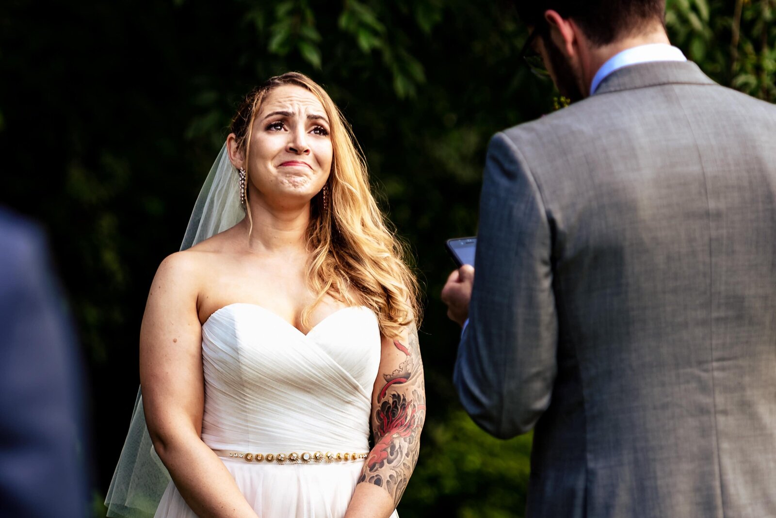 bride holds back tears during wedding vows