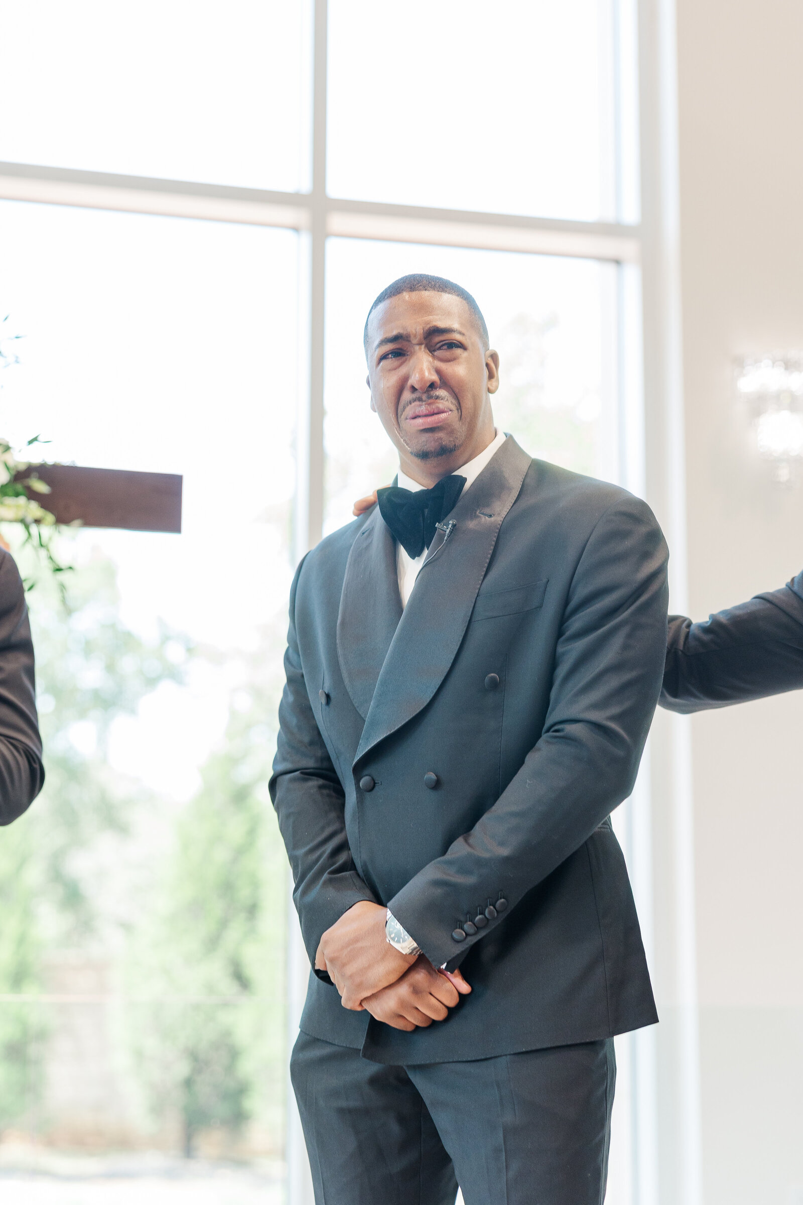 Emotional photography of groom at the ceremony alter