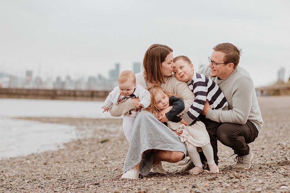 Family of five snuggling at Jericho Beach with Vancouver Family Photographer