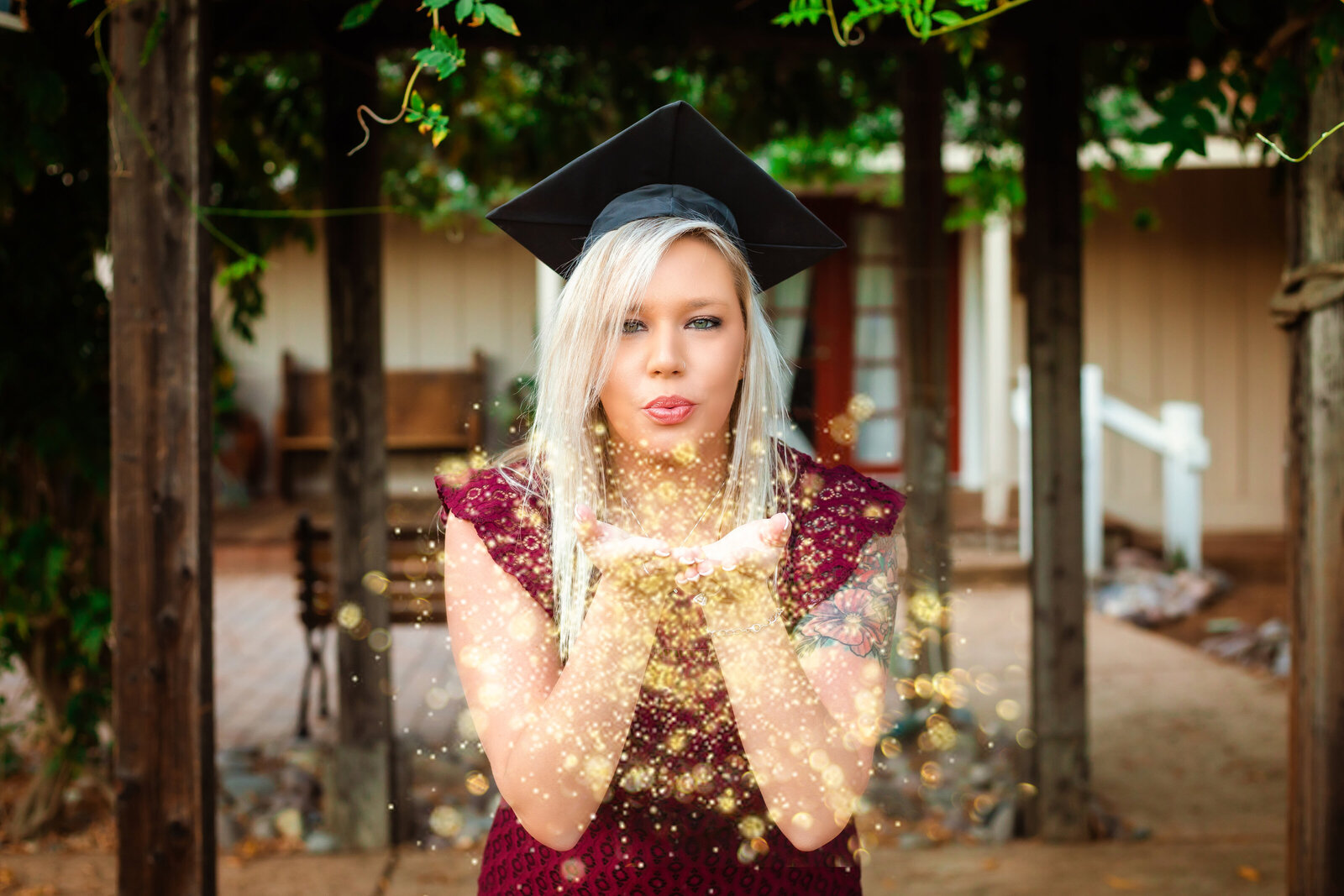 Family Photographer, a graduate woman blows glitter into the air from her hands