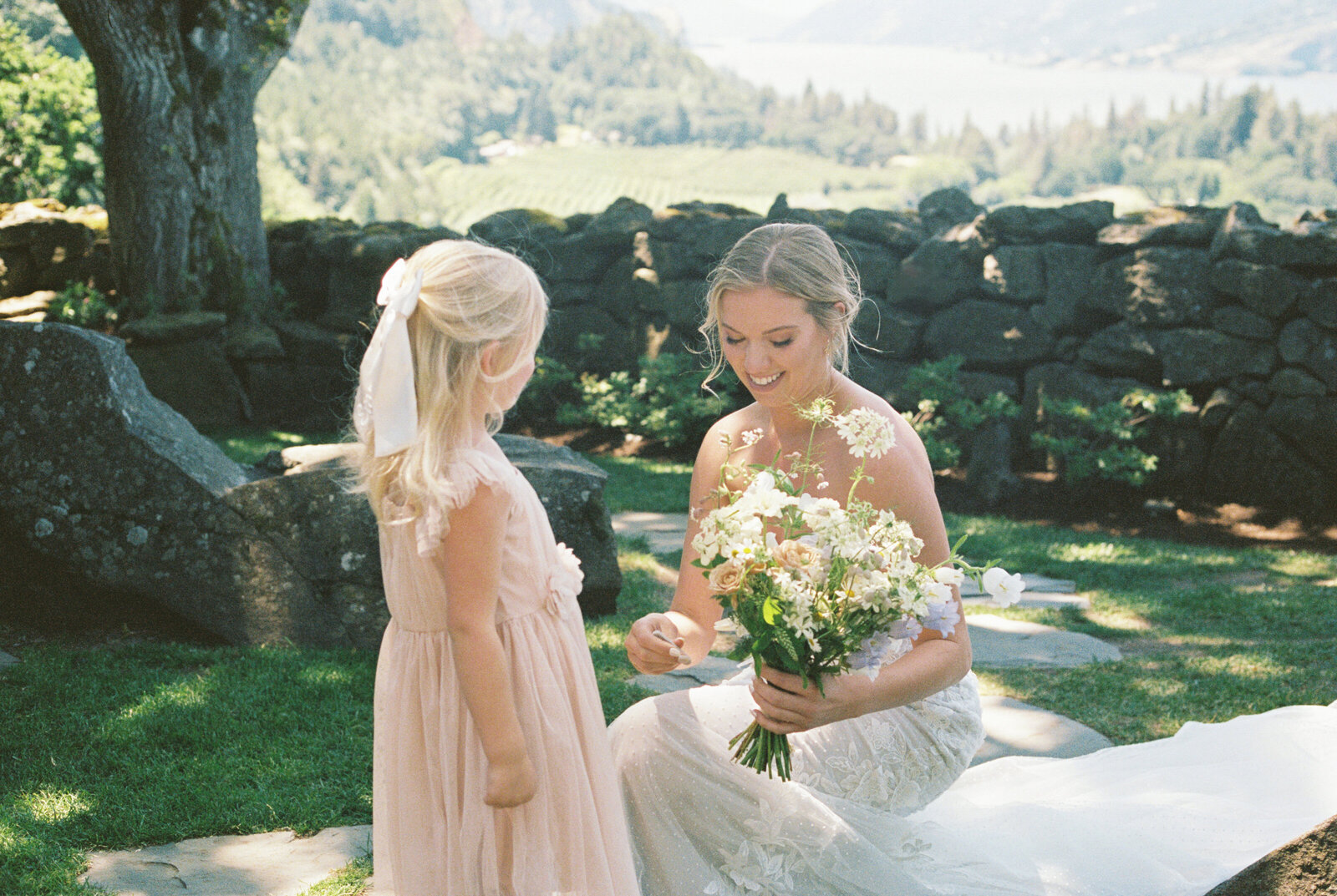 film photo of bride with the flower girl
