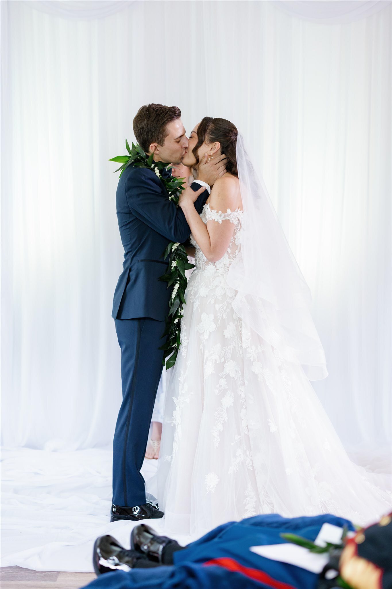 A newlywed couple during their first kiss 