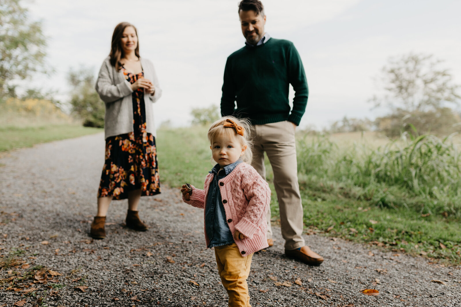 A family walks down a path in a park