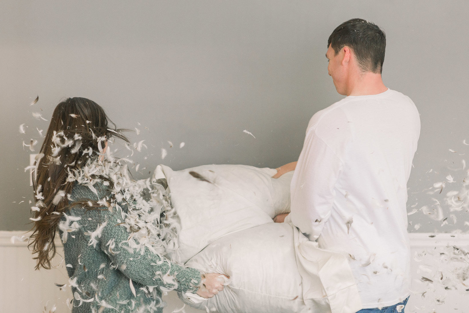 Couple pillow fight captured by Staci Addison Photography