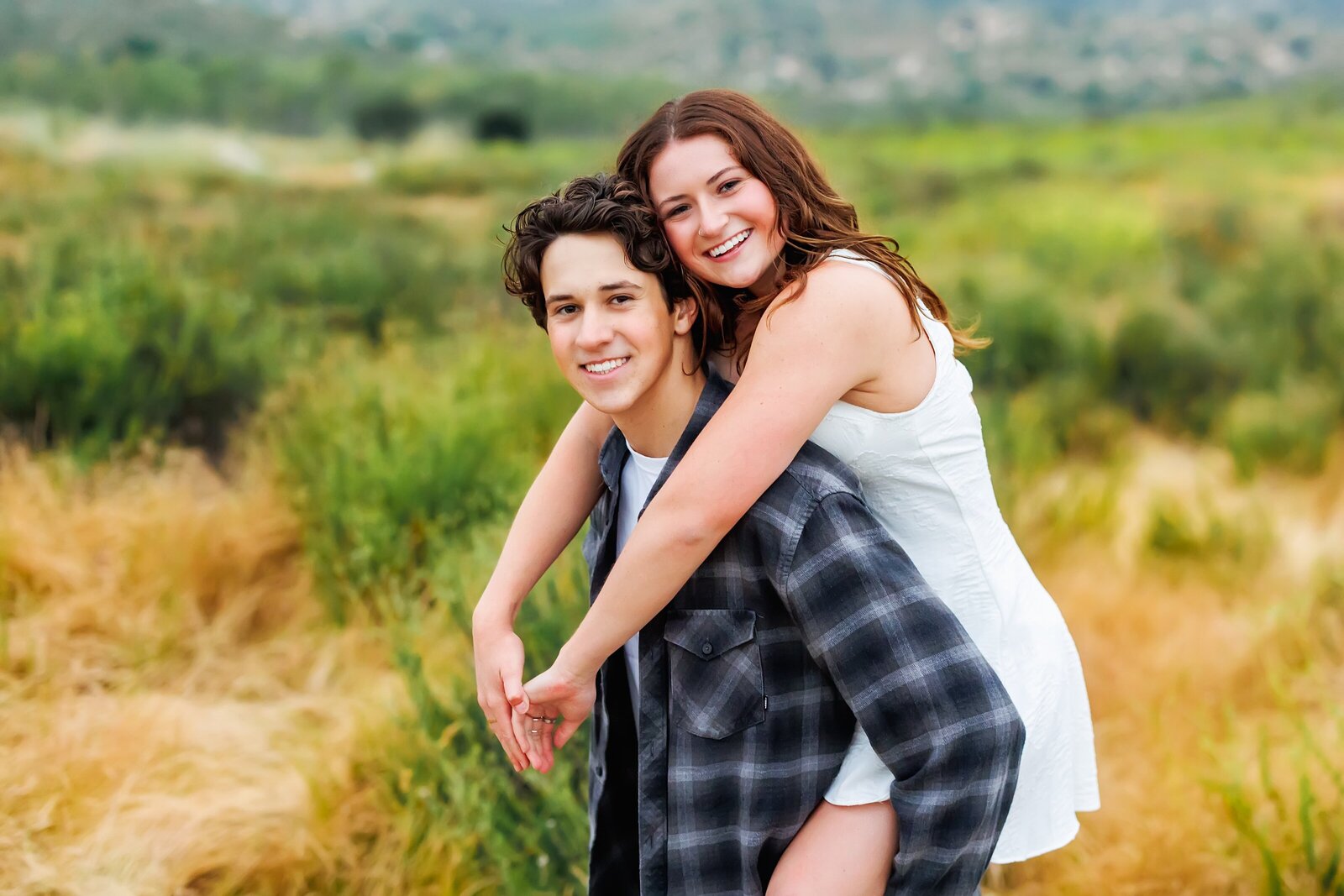 Young couple posing for a portrait taken at San Dieguito River trail in Rancho Bernardo
